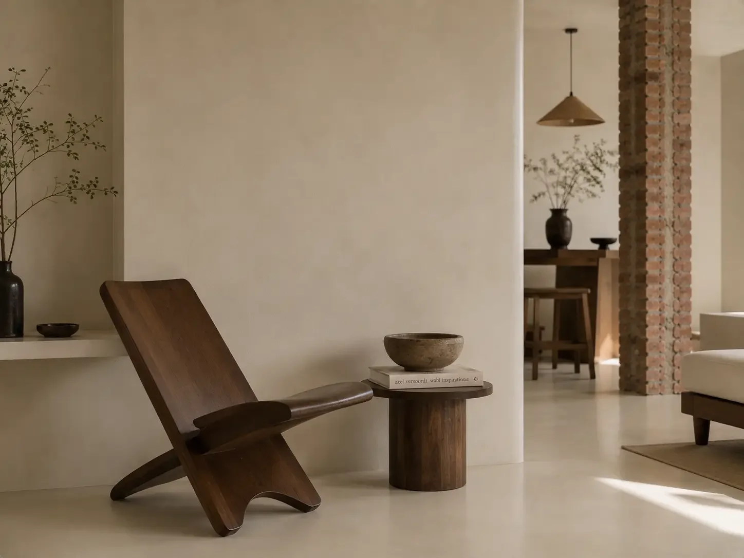 Sculptural wooden furniture against light microcement wall and floor surfaces in a China boutique hotel.