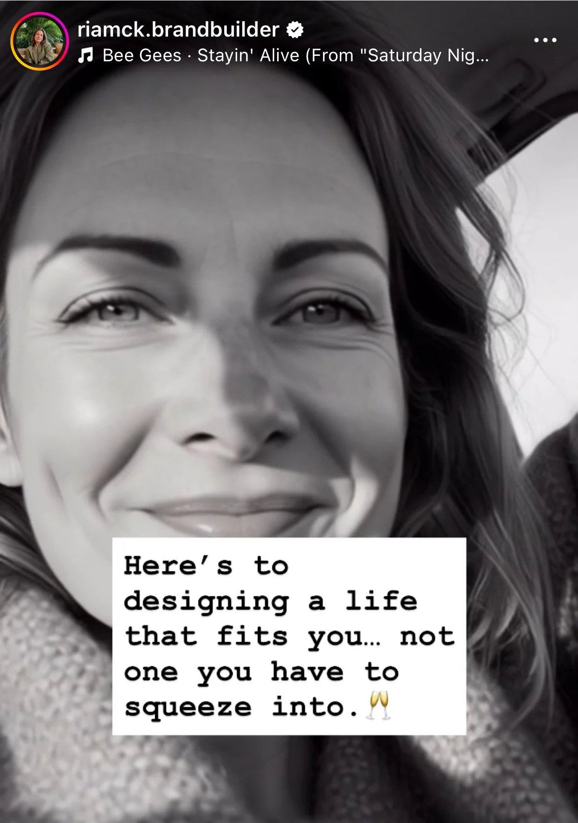 A close-up black and white photo of a woman smiling, with the text overlay: "Here's to designing a life that fits you... not one you have to squeeze into."