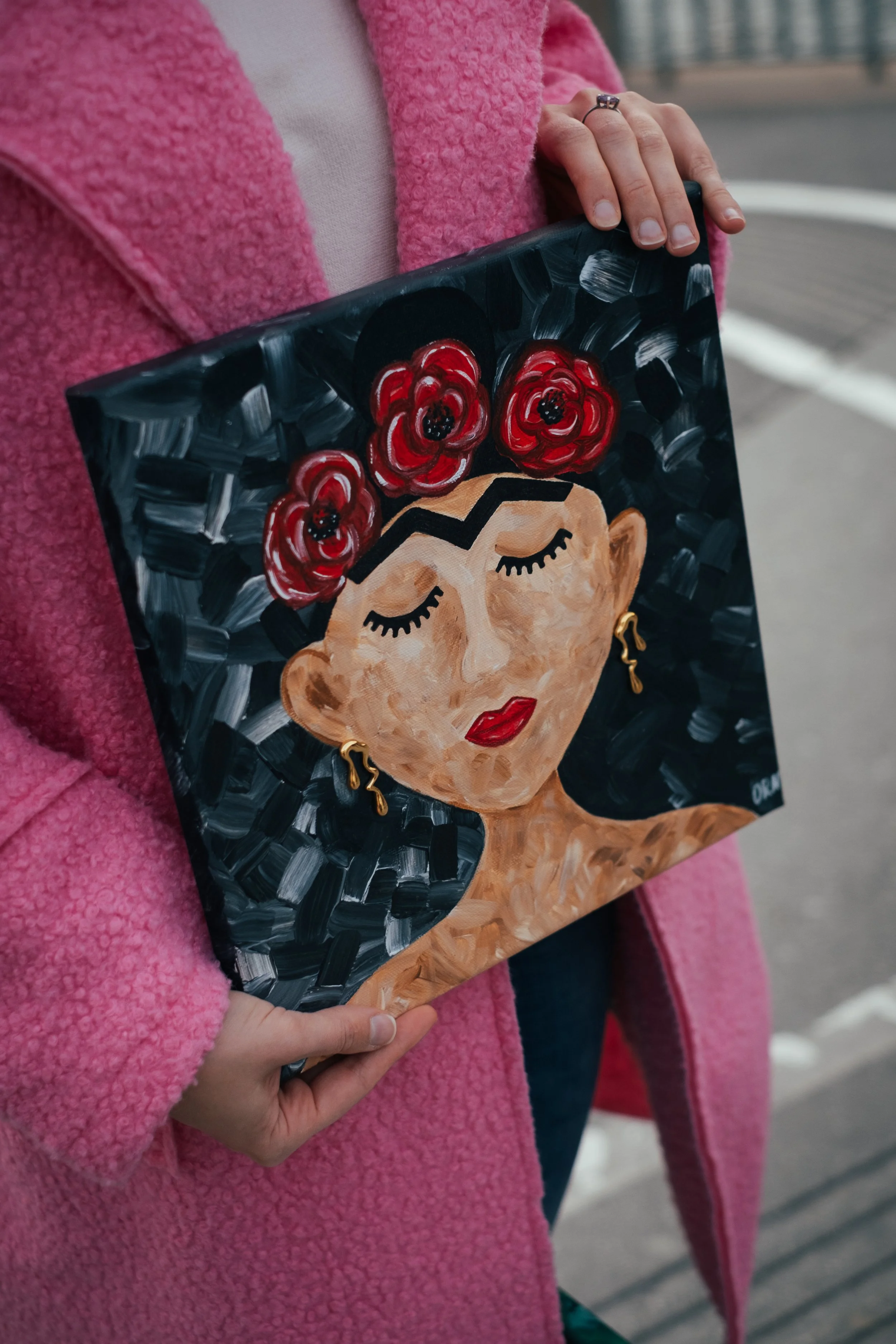 "Frida with Poppies" is a powerful 2025 mixed media painting celebrating the icon Frida Kahlo. The artwork uses bold brushstrokes and tactile elements. Red poppies that symbolize remembrance, resilience, and beauty in contrast to the dark textured ba