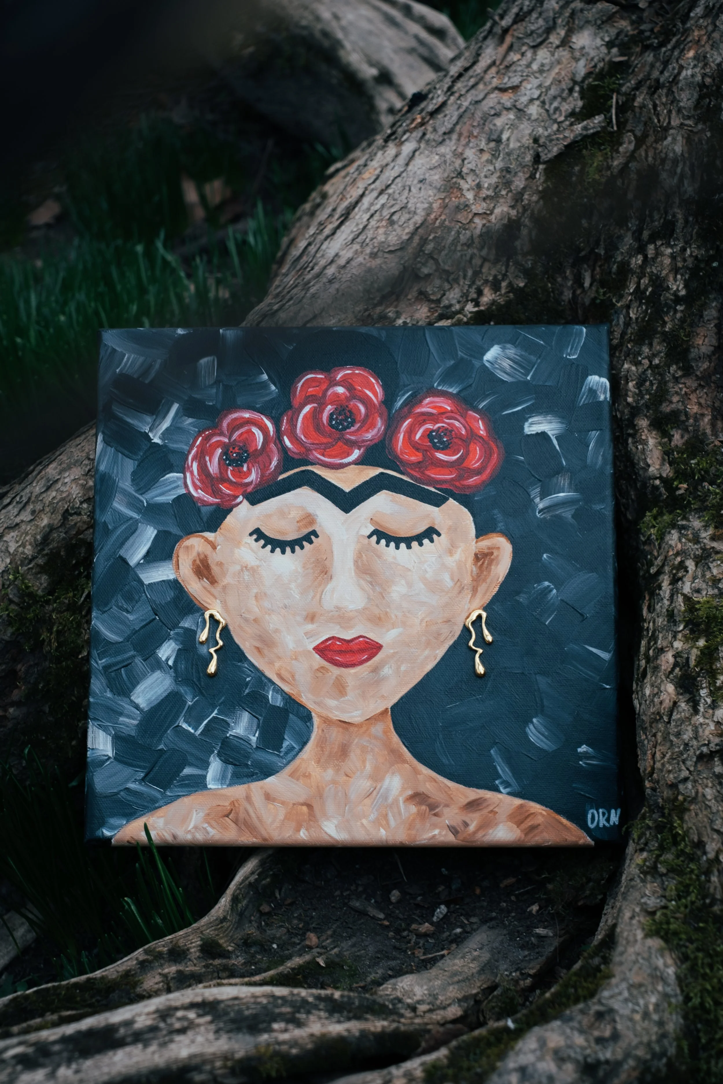 The bold red of the poppies makes "Frida with Poppies" an ideal statement piece for modern urban interiors. The shimmering gold accents and iconic imagery bring a passionate, artistic energy that elevates a minimalist or sophisticated contemporary ro