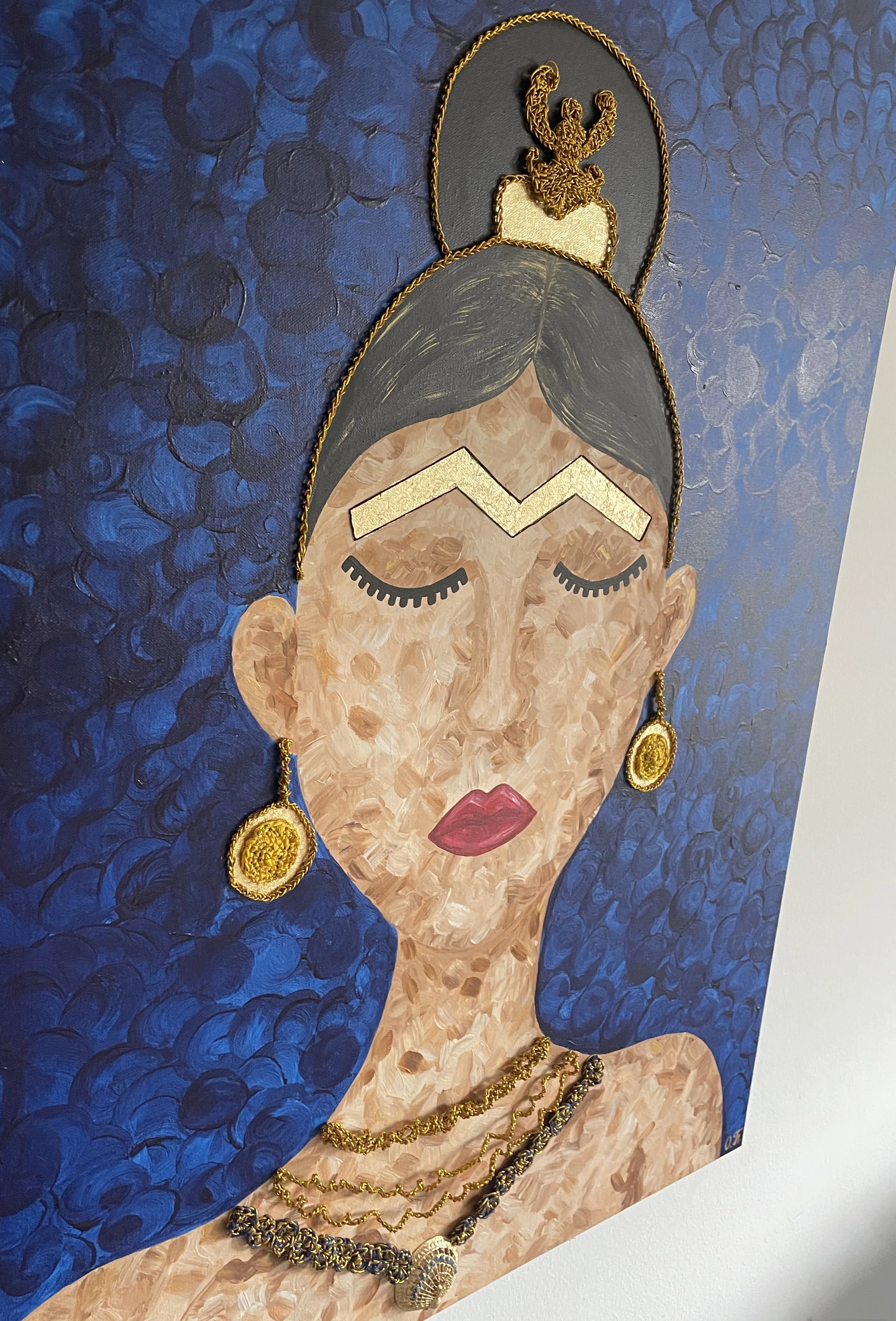 A side-view of Oleksandra Roche-Newton’s "Scythian Goddess" highlights the layered textures of the canvas. The painting features a powerful woman adorned with sacred Scythian-inspired jewelry, symbolizing protection, lineage, and the strength of woma