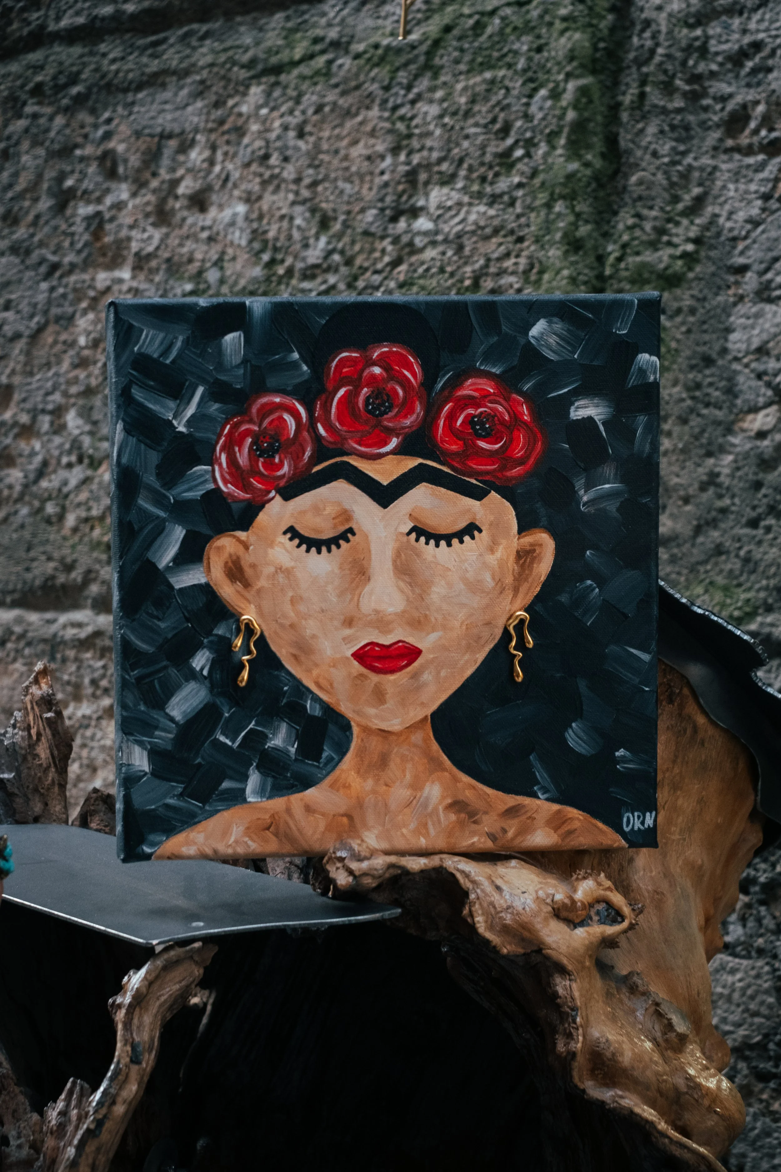 Acrylic painting of Frida Kahlo with closed eyes and red lips, featuring deep red poppy flowers contrasted against a dark, dynamic grey and black impasto background.