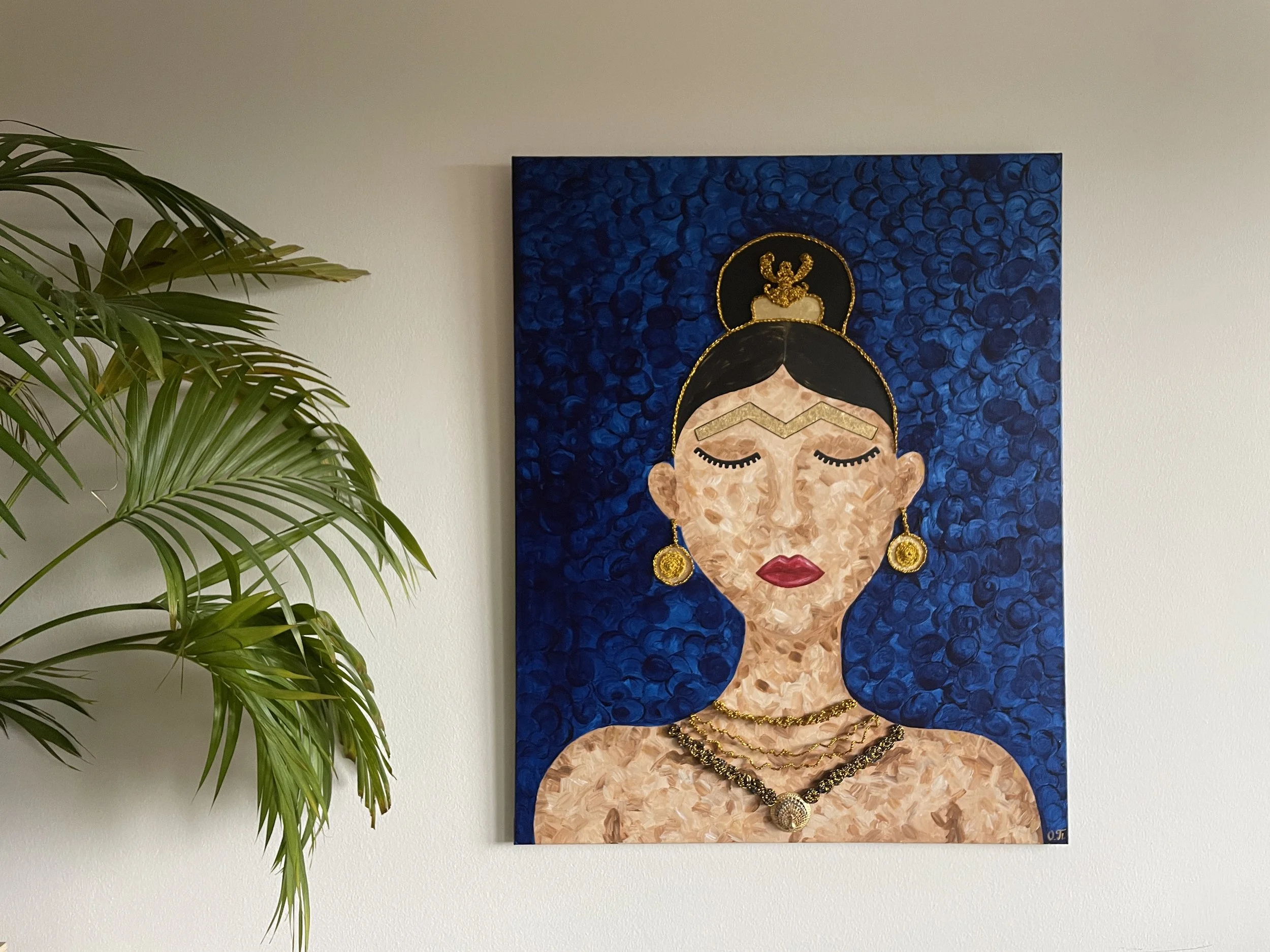 This piece bridges the gap between ancient history and modern design. The rich Scythian-inspired gold jewelry pops against the textured blue backdrop, bringing a sense of protection and feminine strength to any room. Whether placed in a quiet study o