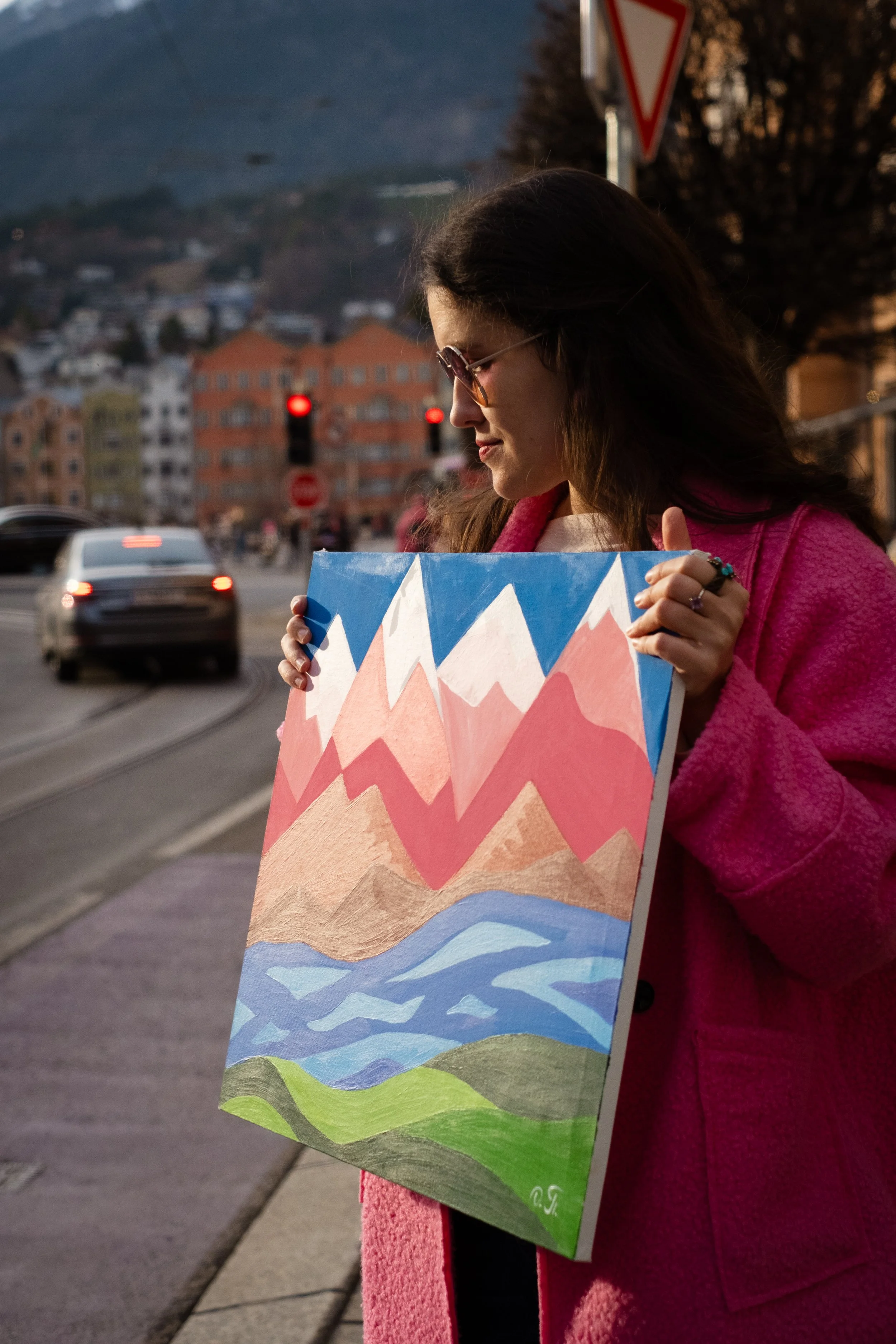 Close-up detail of "Pink Mountains" painting by Oleksandra Roche-Newton  showing thick acrylic brushstrokes and the transition between deep red and bright pink mountain layers.
