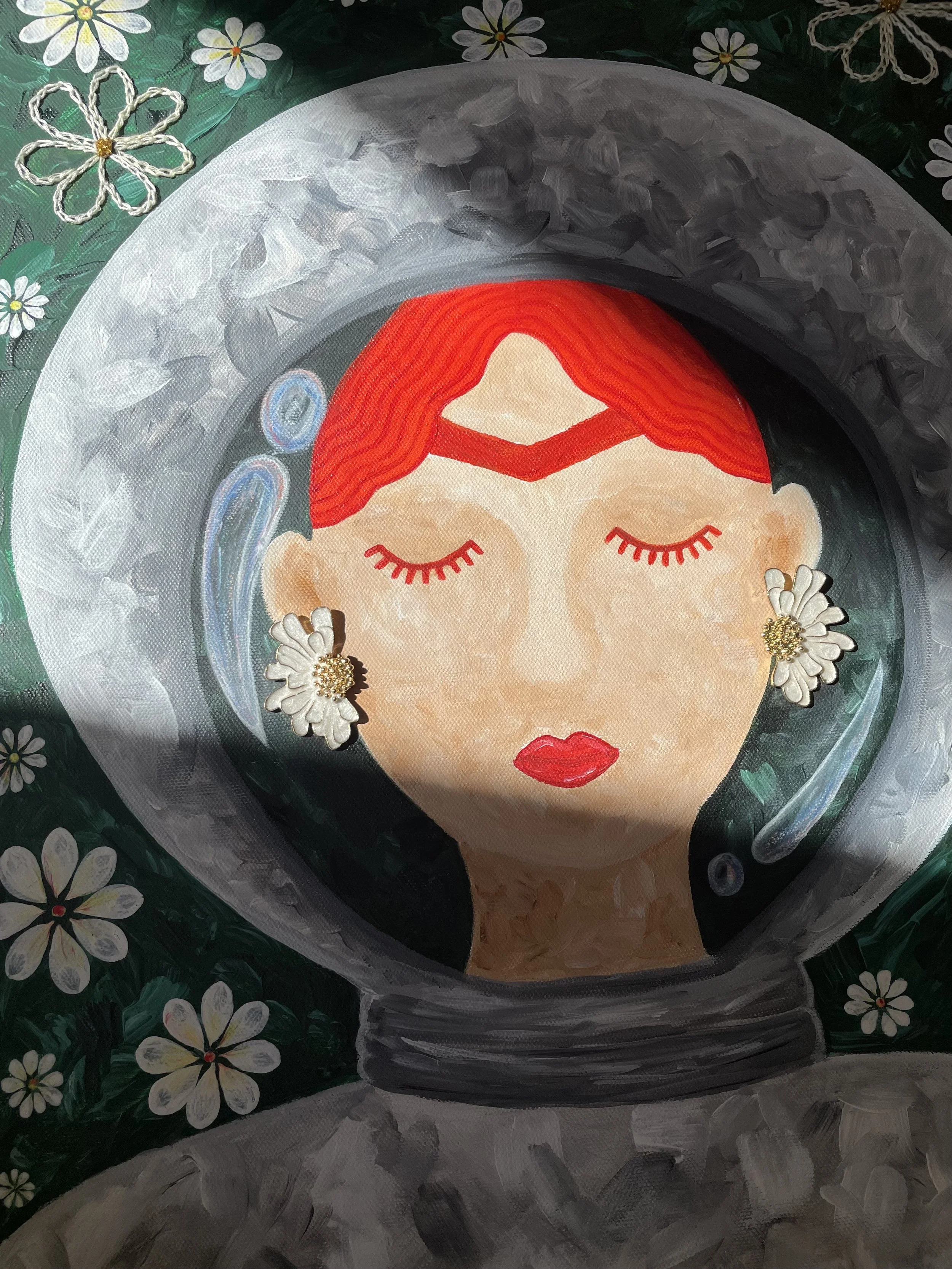 A focus on the serene expression of "Space Frida." The character’s red hair and signature daisy earrings symbolize the spring breeze and cozy internal universe that the artist associates with peace and dreaming.