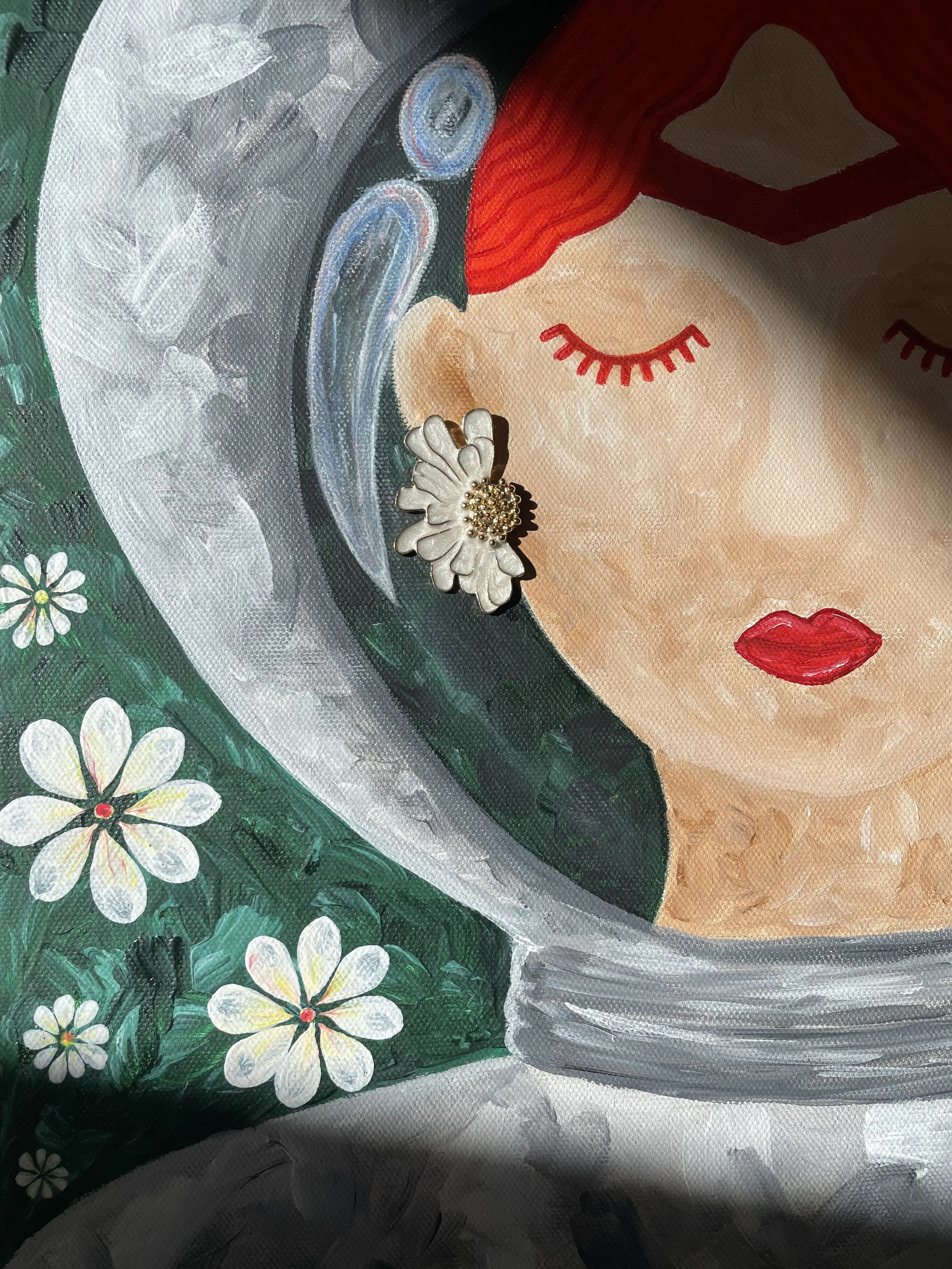 Close-up of the "Space Frida" canvas by Oleksandra Roche-Newton, highlighting the silver astronaut suit and the hand-painted floral patterns.