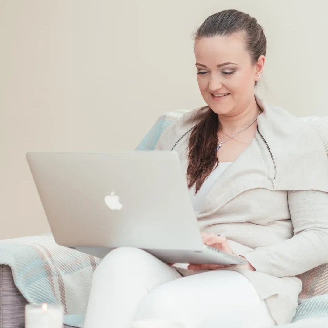 Woman working on a laptop at home while designing a website