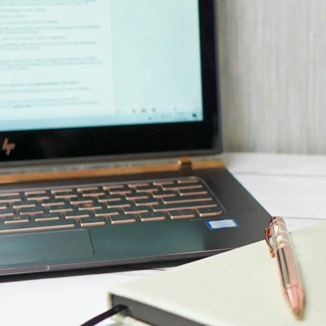Laptop and notebook on a desk showing website SEO work in progress