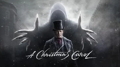 Promotional poster for 'A Christmas Carol' featuring a man in period attire and a large shadowy figure with outstretched hands in the background.