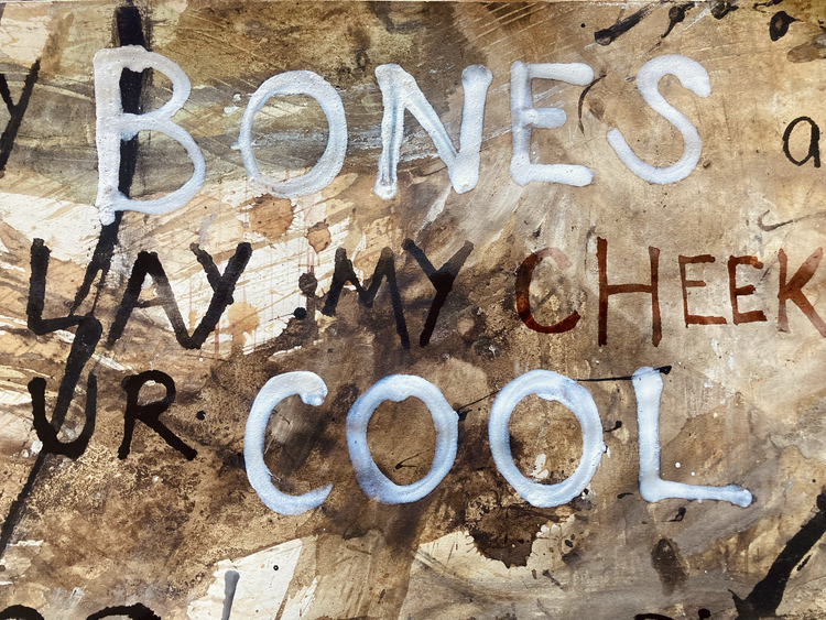 Text on a wooden surface in mixed black and white writing.