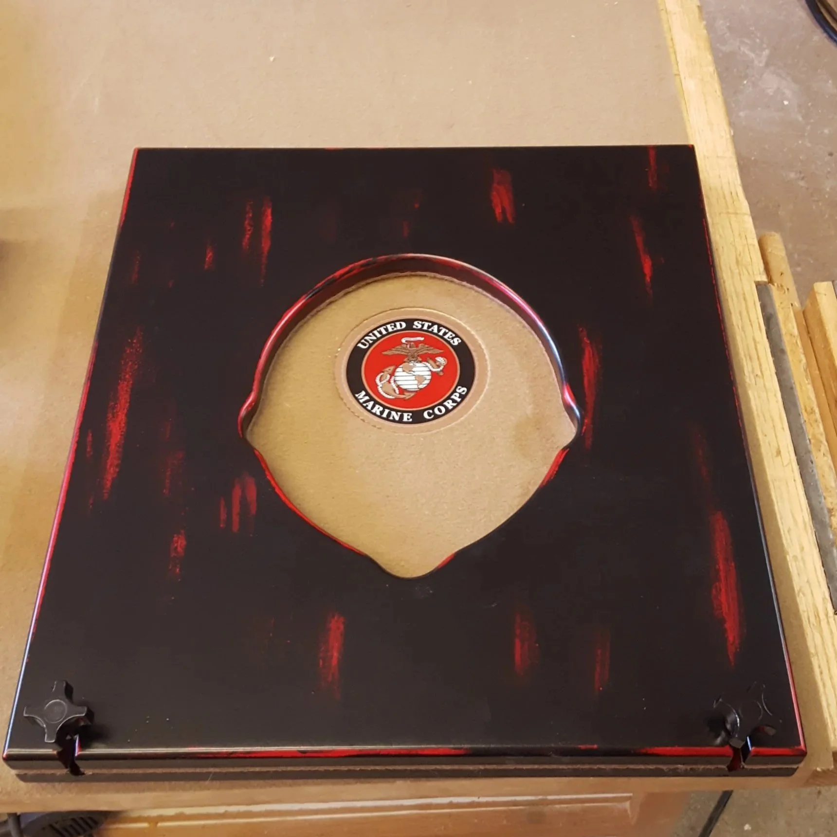 A box with a United States Marine Corps emblem inside a circular cutout.