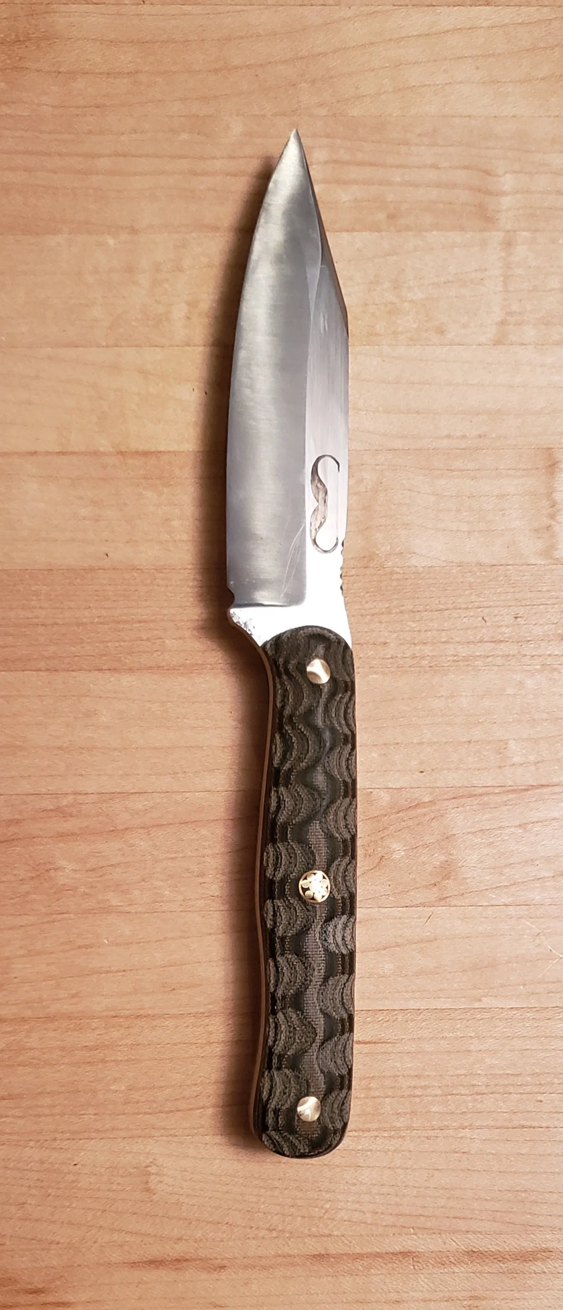 A folding pocket knife with a textured black handle and a partially open shiny silver blade.