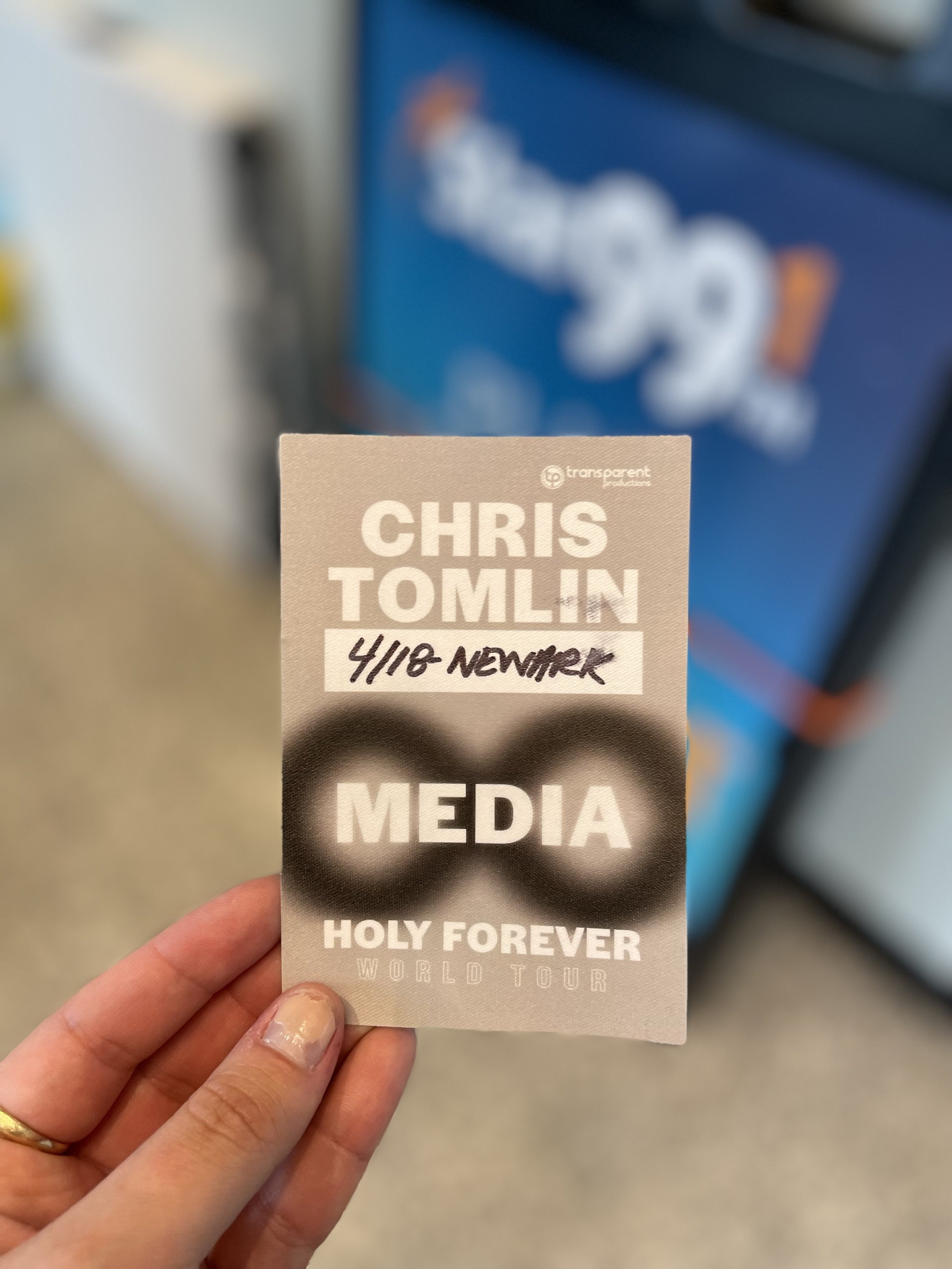 Hand holding a ticket for Chris Tomlin's Holy Forever World Tour, with the date 4/18 November.
