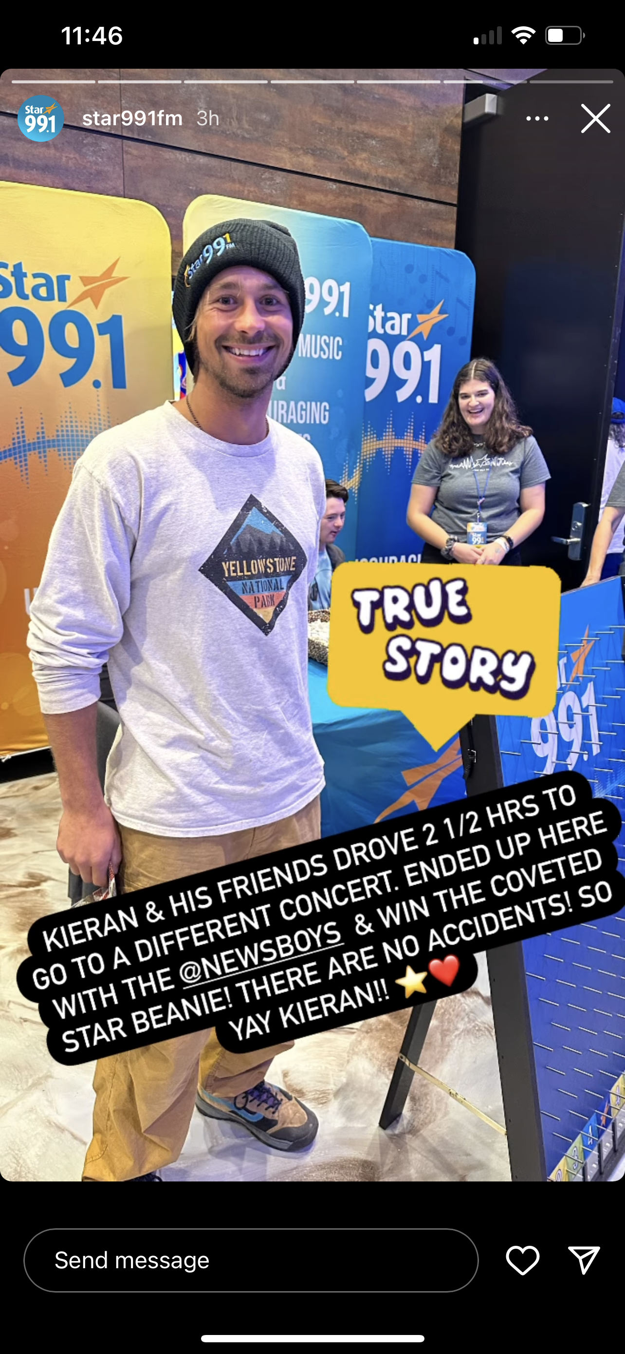 Man smiling at a Star 99.1 event, wearing a beanie and gray sweatshirt, with two women in the background at a table with Star 99.1 banners, and a yellow speech bubble reading 'TRUE STORY'.