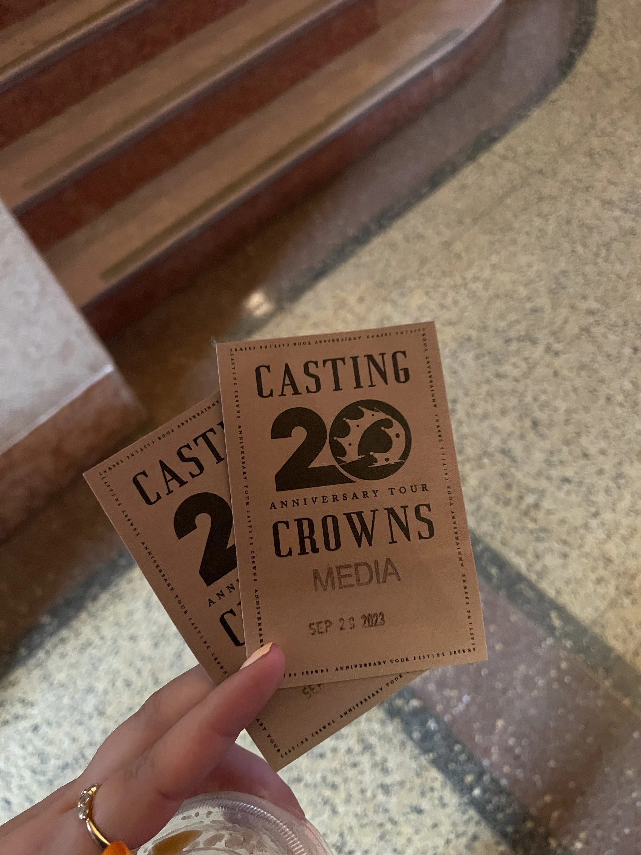 Two tickets for the 20th anniversary tour of Casting Crowns, dated September 23, 2023, being held at a venue with stairs and a textured floor.