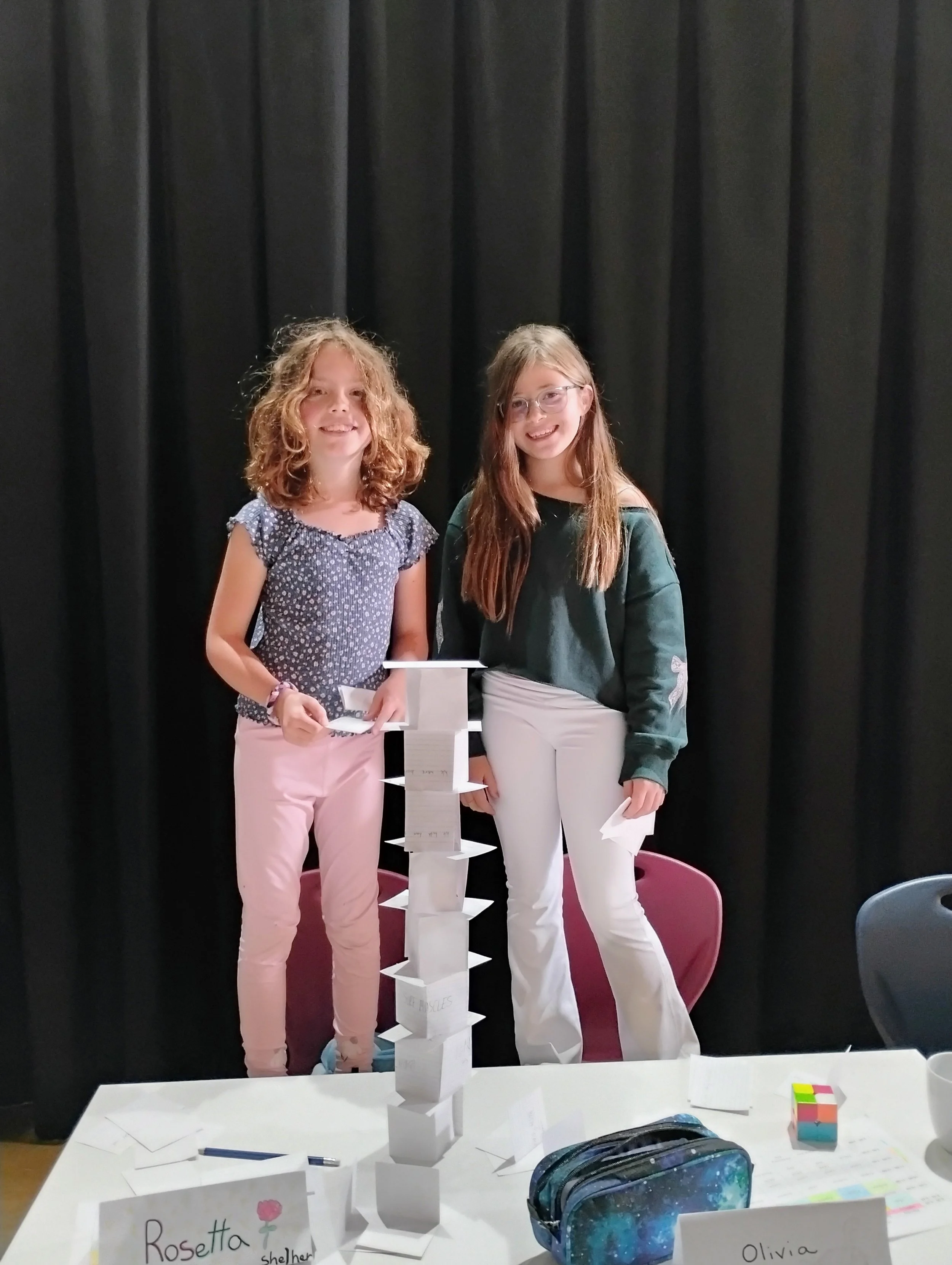 Students with a tall paper structure project