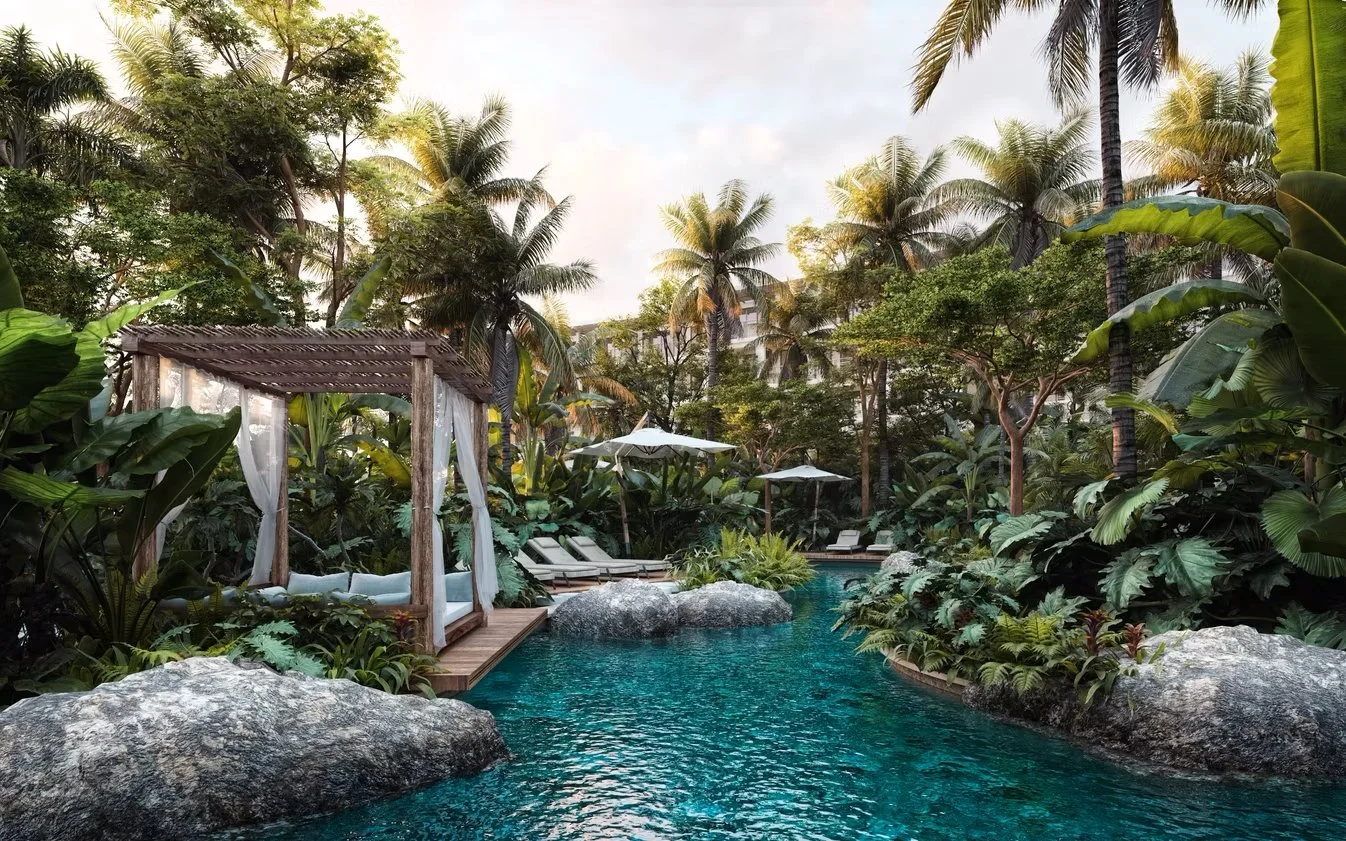 A tropical pool area surrounded by lush green trees and plants, including palm trees and large leaves. There are lounge chairs, umbrellas, and a wooden swing with white curtains over the pool in a serene, lush environment.