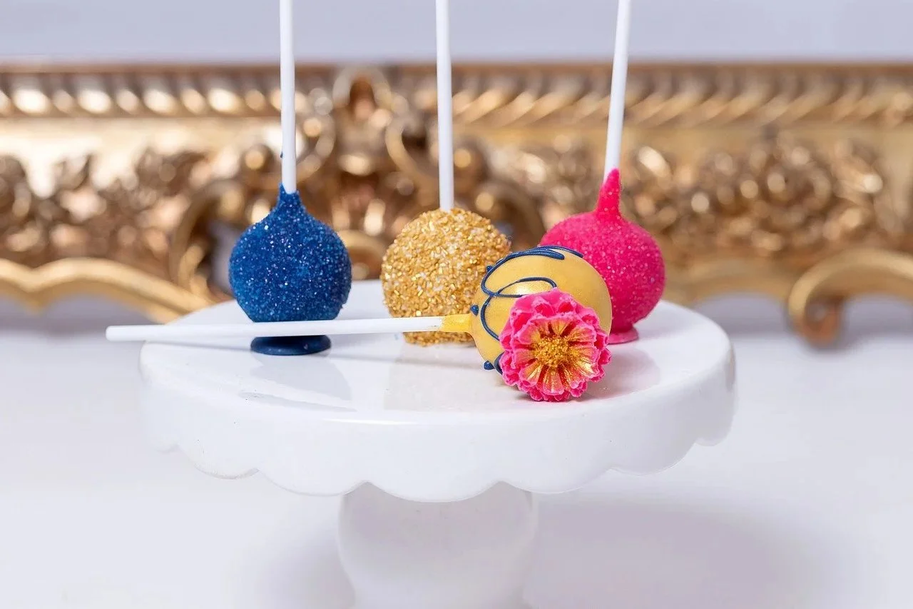 Laurie’s customers, Mariana and Carmen holding hands on a green lawn on their wedding day.