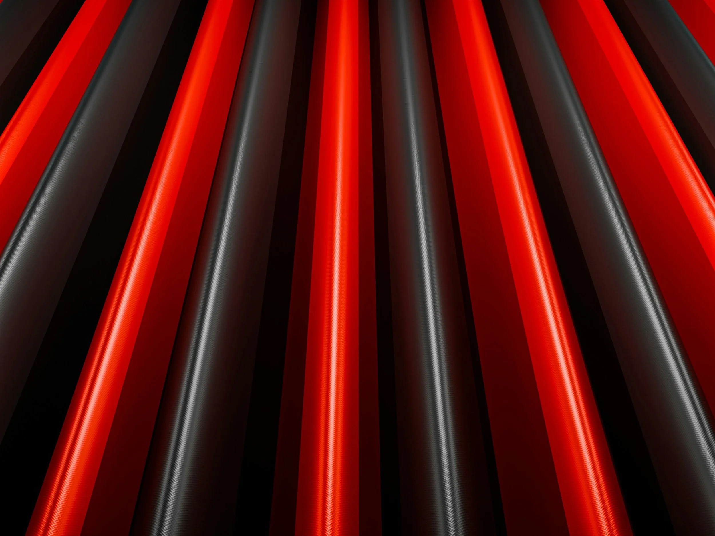Close-up of several black and red cables or tubes aligned in diagonals, with a glossy and textured surface against a dark background.