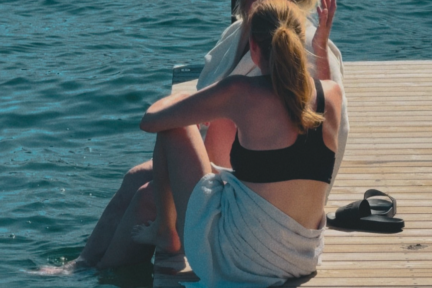 Woman enjoying waterfront cold plunge after Nordic sauna ritual in Copenhagen