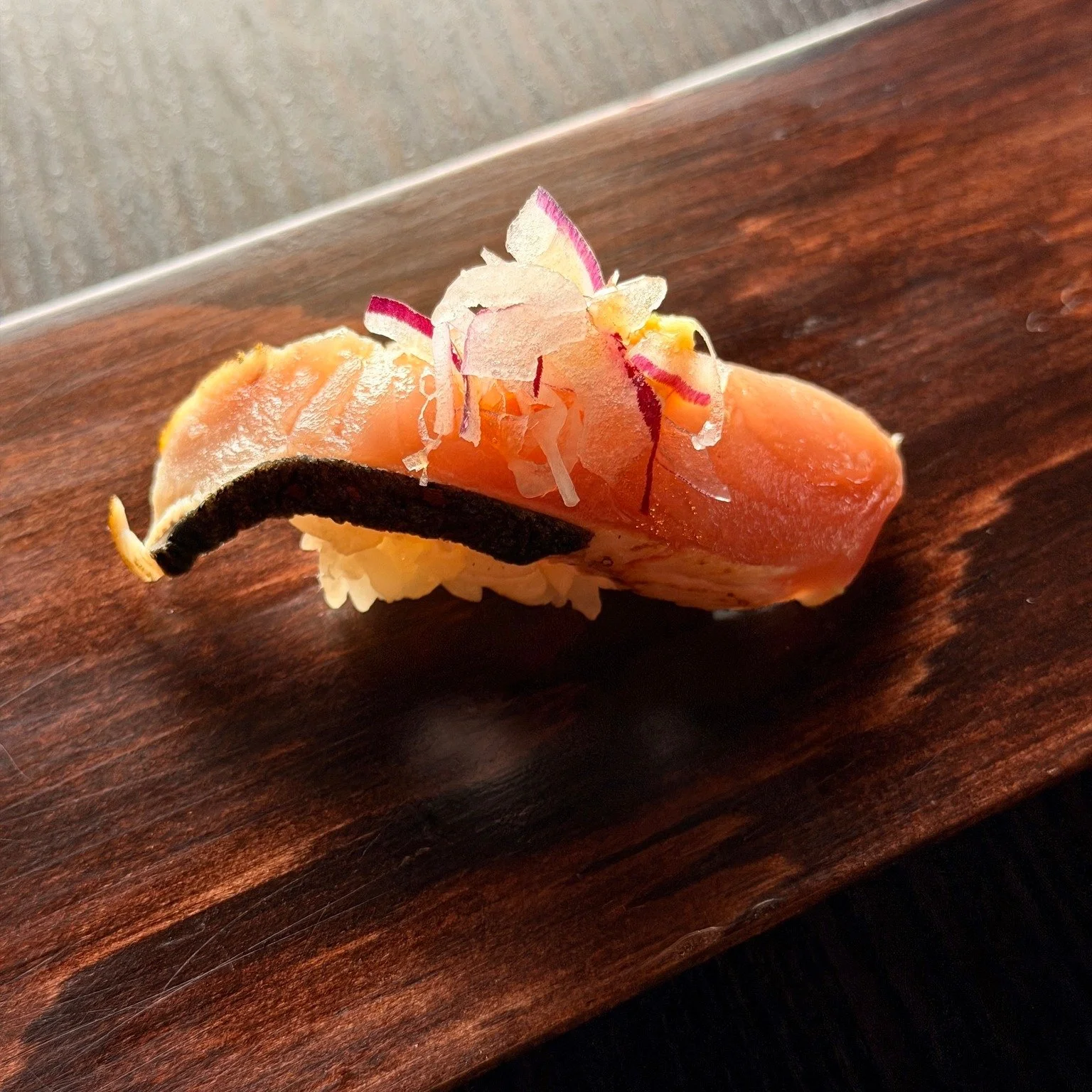 Bonito, lightly kissed by flame.
Smoky, delicate, and layered with quiet depth.

Finished with shaved radish and a touch of citrus&mdash;
a balance of ocean, fire, and freshness in one bite.

This is simplicity, done right.

#nagisasushi #bonito #nig