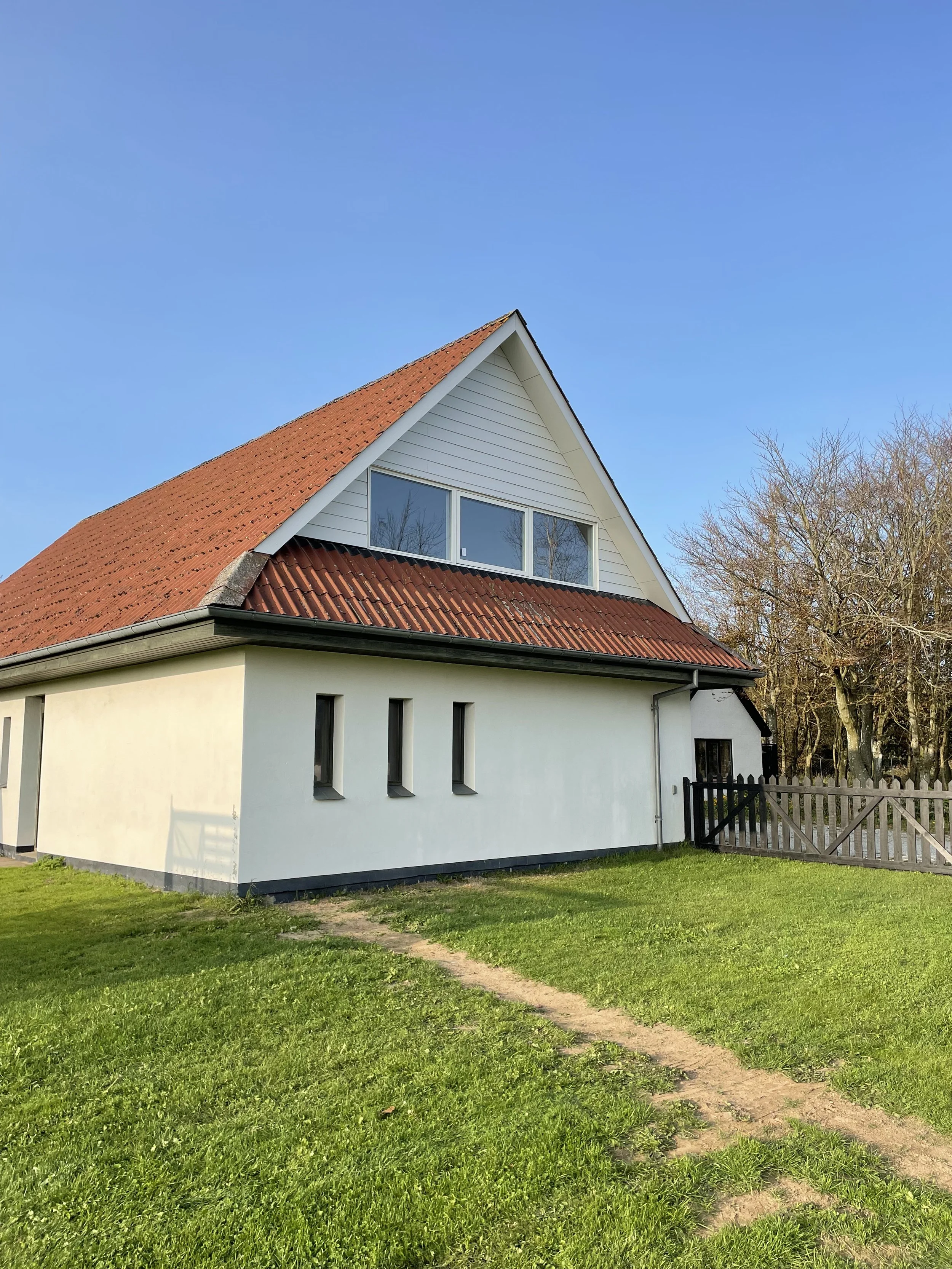 Færdig gavl med hvid hardieplank og rationel vinduer.