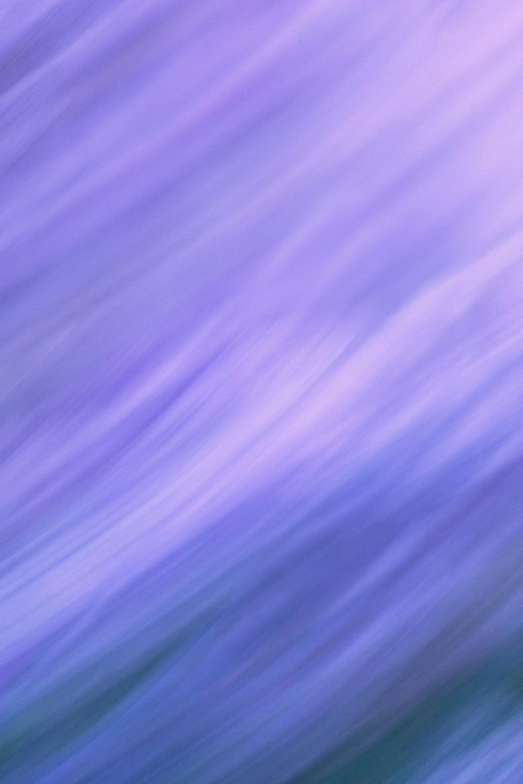 Blurred image with shades of purple, blue, and green, creating a motion-like streak pattern.
