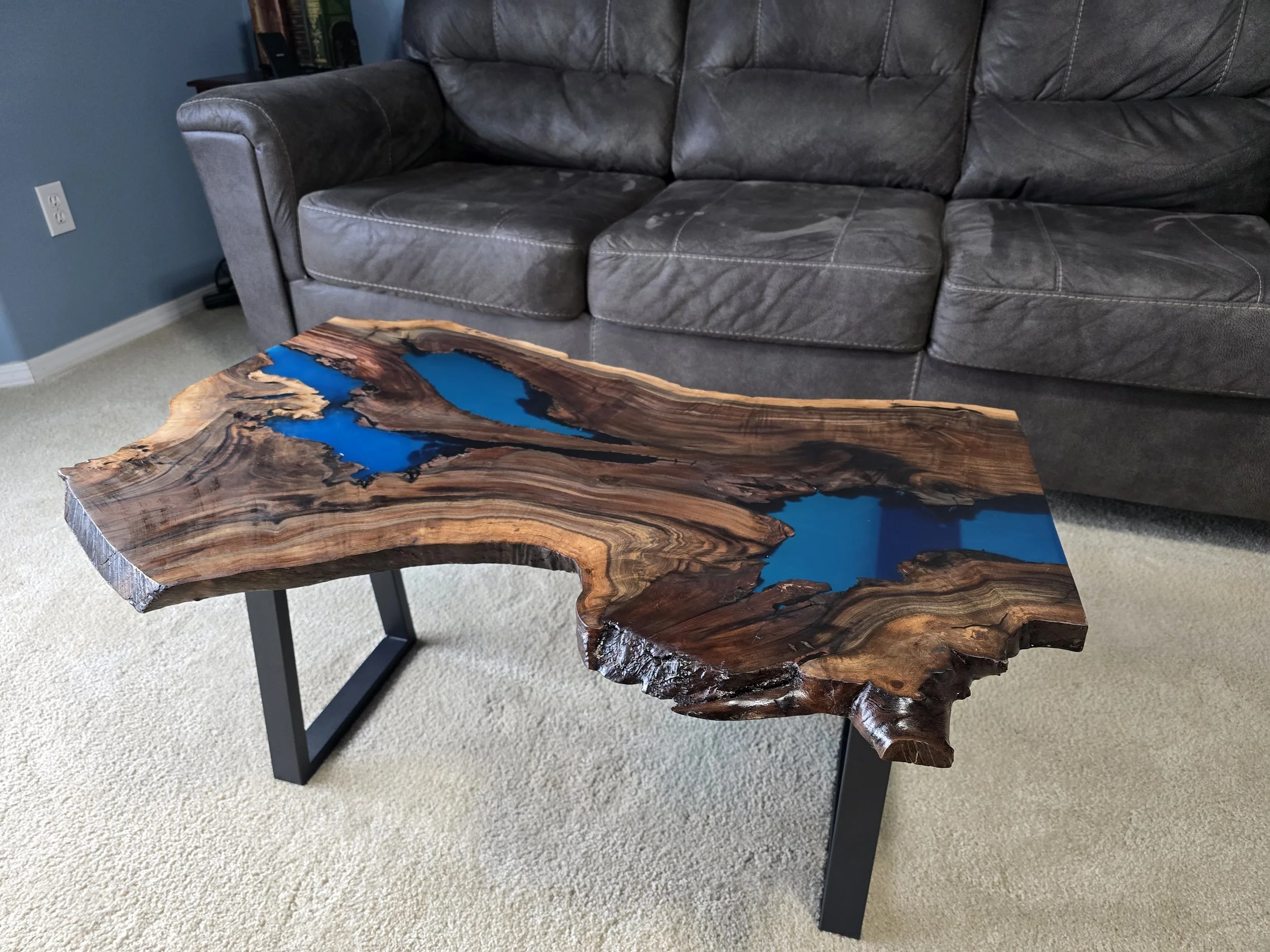 live edge coffee table made from walnut and blue epoxy with metal legs