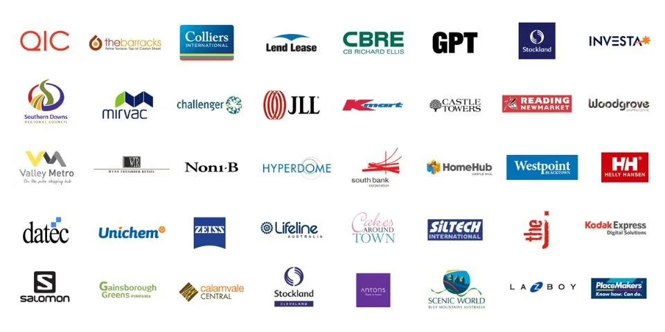 A collection of various company logos on a white background, including QIC, Colliers International, CBRE, GPT, Stockland, Investa, Mirvac, Challenger, JLL, Kmart, Castle Towers, Reading Newmarket, Woodgrove, Valley Metro, Noni-B, Hyperdome, South Bank, Westpoint, Helly Hansen, datec, Unichem, Zeiss, Lifeline Australia, Cafe Around Town, Siltech International, Kodak Express, Salomon, Gaisborough Greens, Calamvale Central, Stockland, Antons, Scenic World, La-Z-Boy, and PlaceMakers.