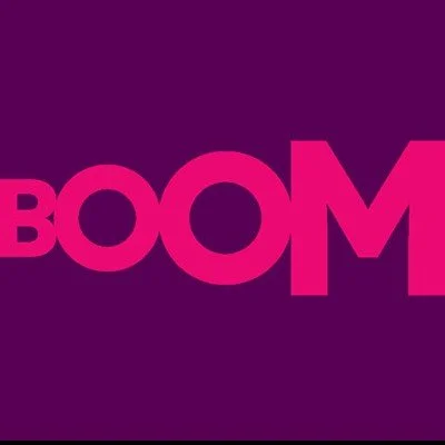 Bold pink text spelling 'BOOM' on a dark purple background.