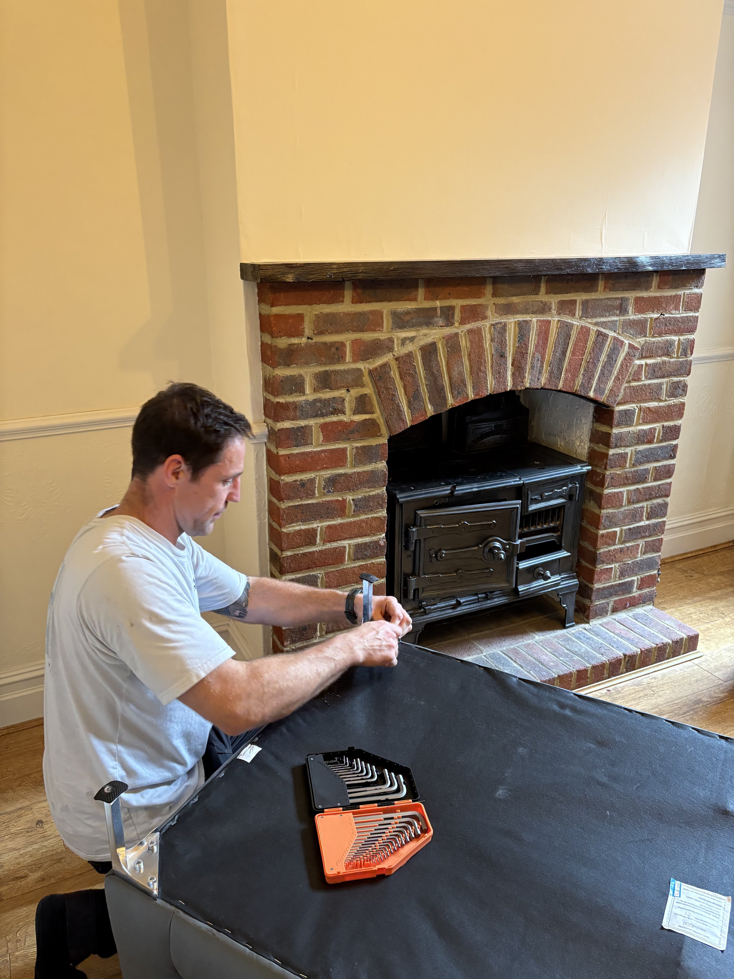 Don reassembles furniture after a house move