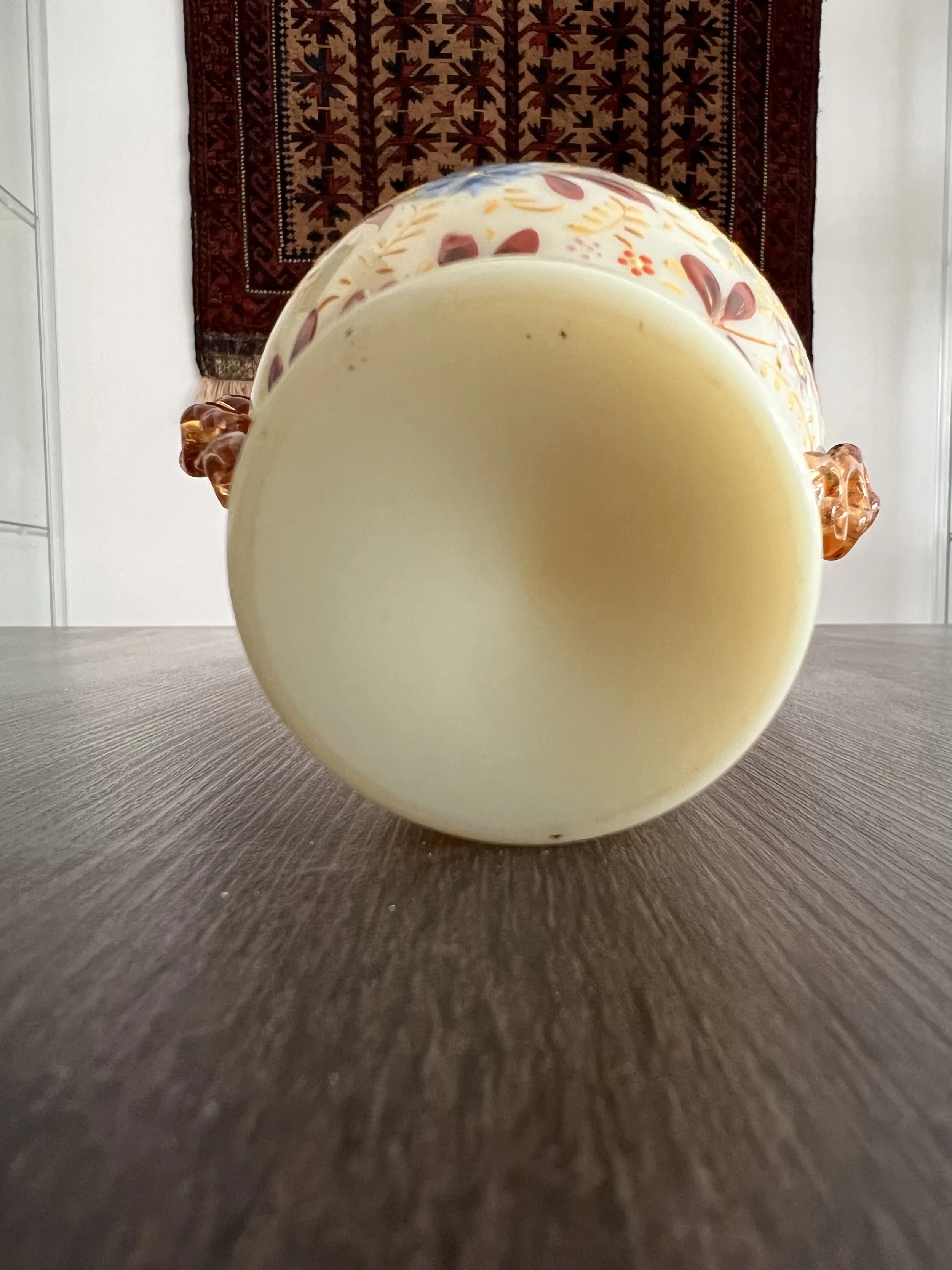 Antique ivory opaline glass vase with hand-painted enamel floral decoration, gilt accents, and applied amber glass handles, circa 1900.