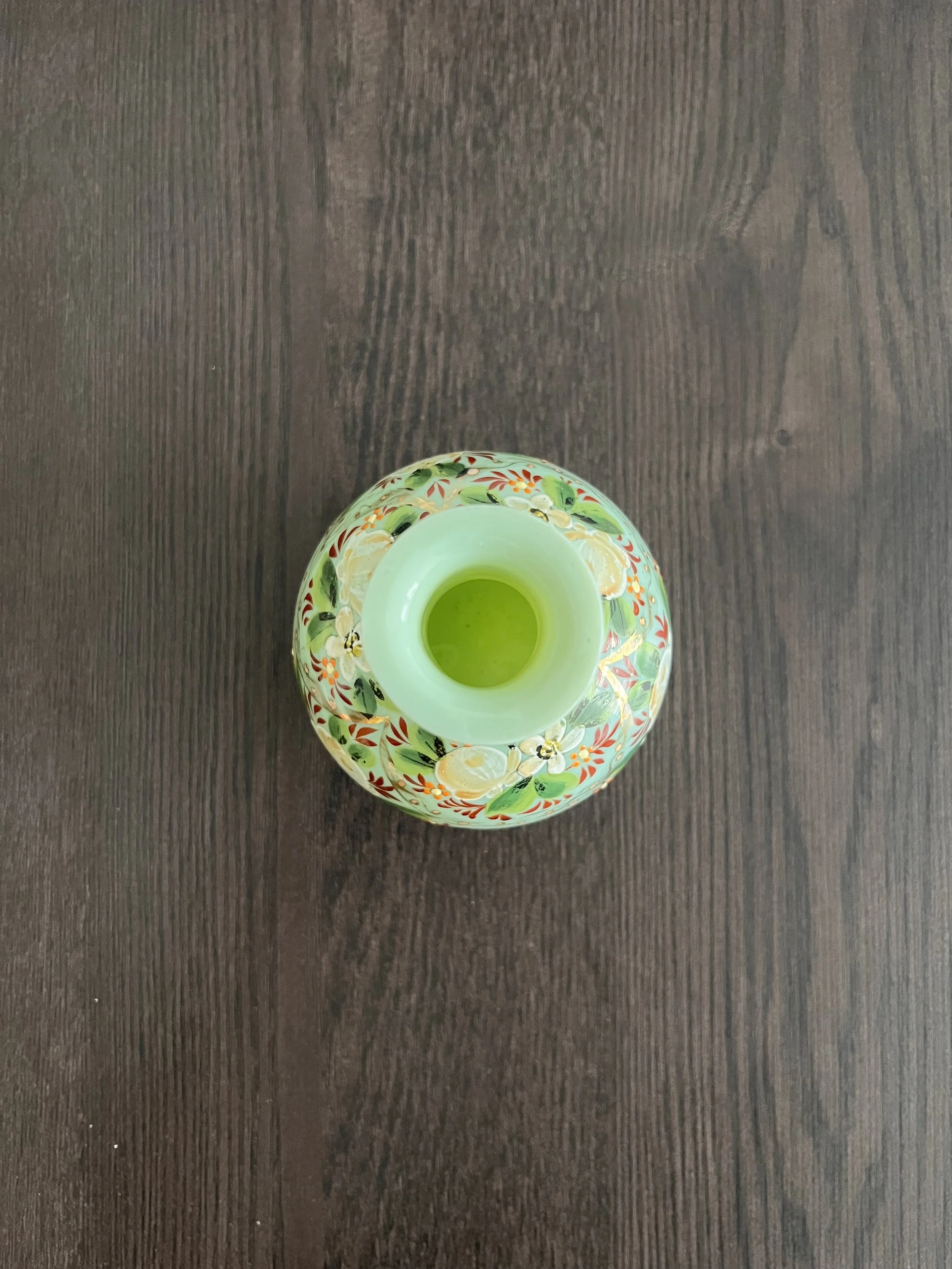 Authentic 19th-century French opaline glass vase in pistachio green. Features hand-painted enamel florals and gold gilt. Perfect for antique collectors.