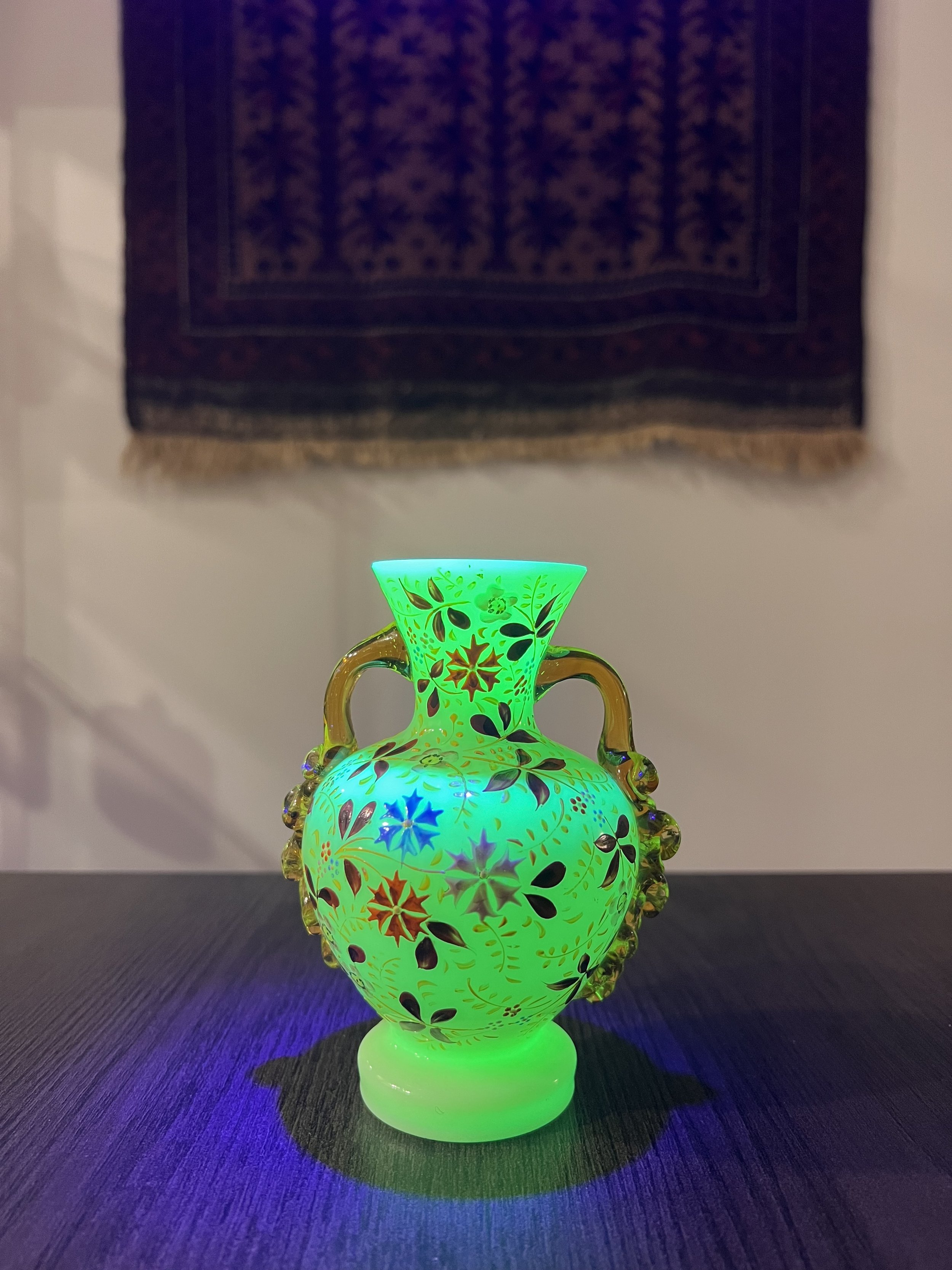 Antique ivory opaline glass vase with hand-painted enamel floral decoration, gilt accents, and applied amber glass handles, circa 1900.