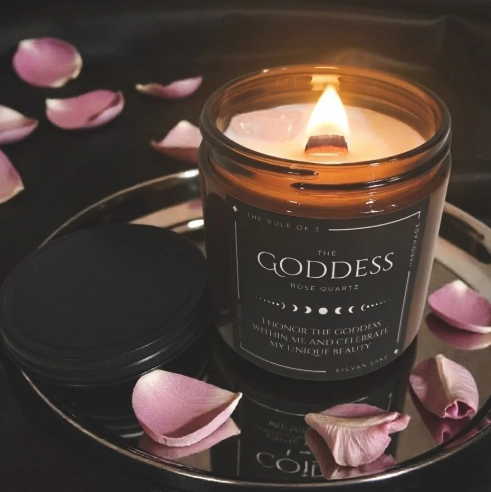 Amber jar Goddess candle with rose quartz, floral fragrance notes, and wood wick—used for intention setting, meditation, and self-love rituals.