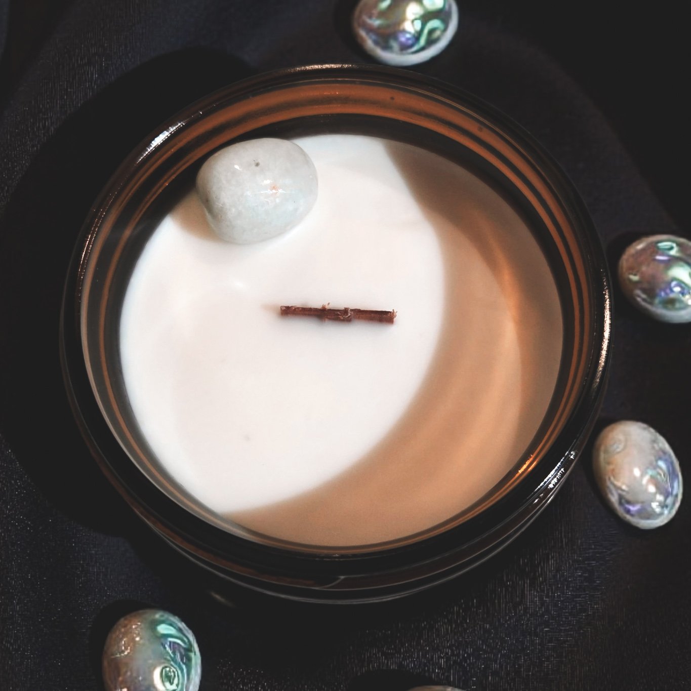 “Top view of The Mermaid candle featuring amazonite crystal pieces embedded in creamy soy wax.”