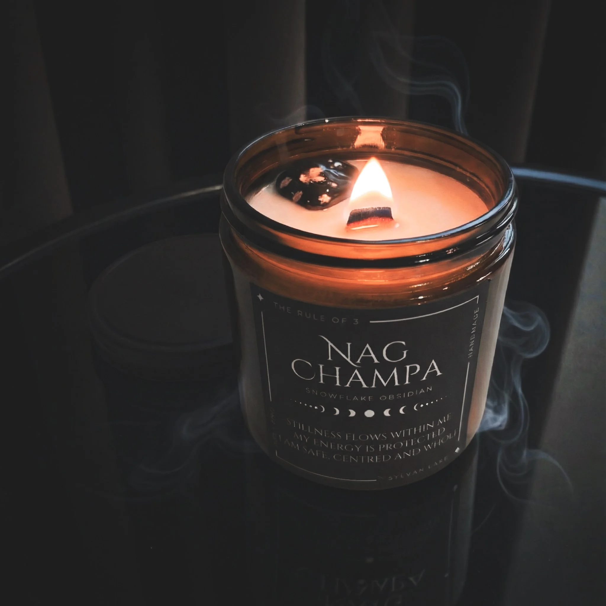 “Lit Nag Champa ritual candle with a crackling wood wick, styled with spiritual incense-inspired elements on a dark background.”