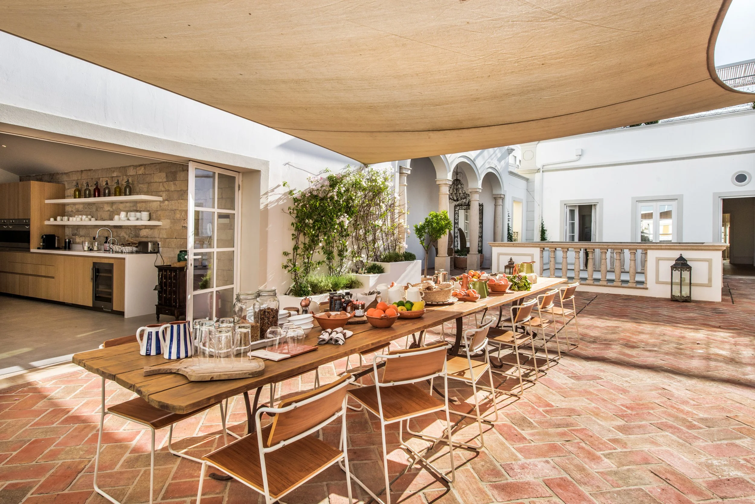 Outdoor dining area with shared meals at the Olhão retreat house