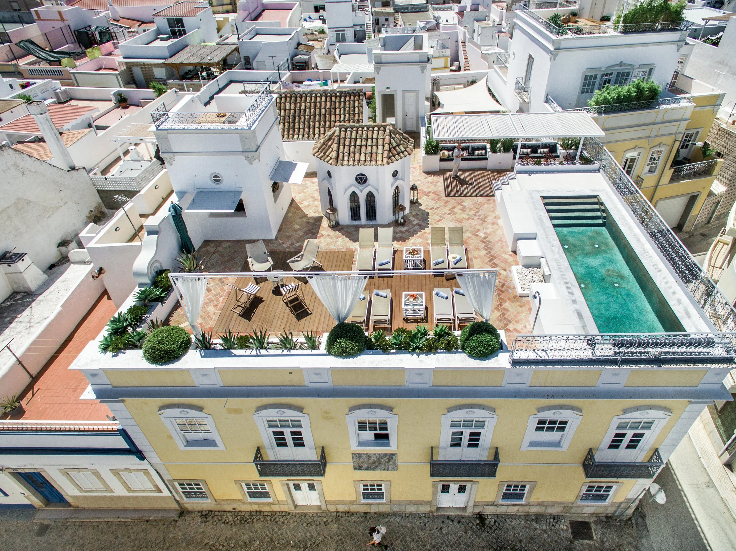 Aerial view of the Olhão retreat house with rooftop terrace and pool in Portugal
