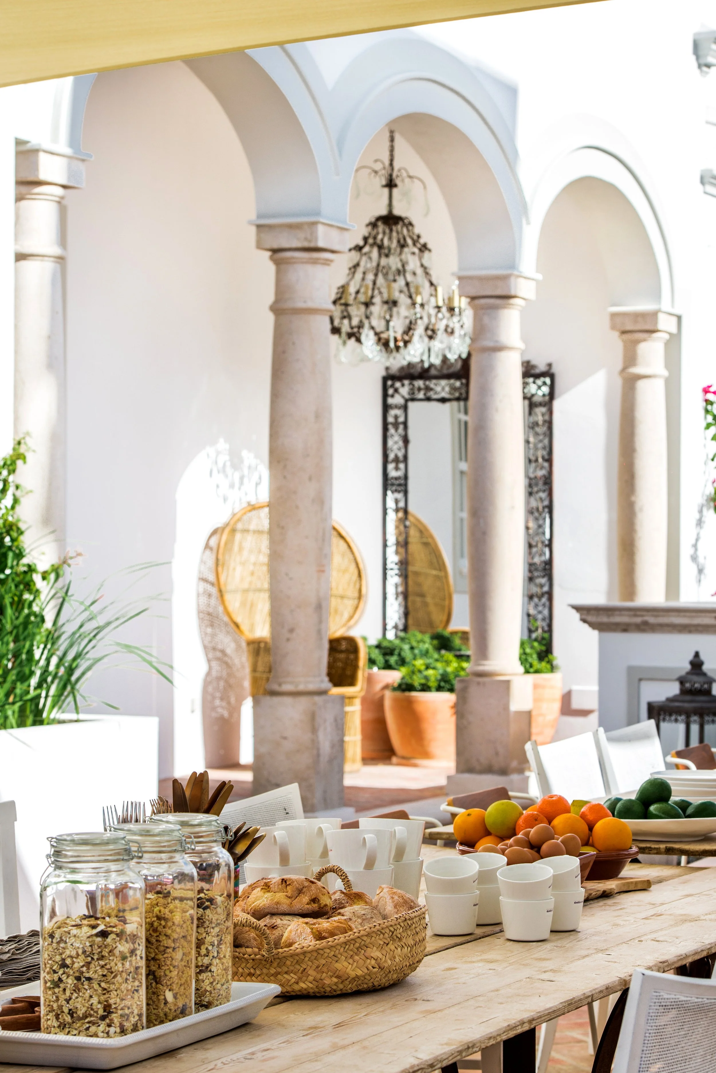 Bright courtyard and interior lounge space at the Olhão retreat house
