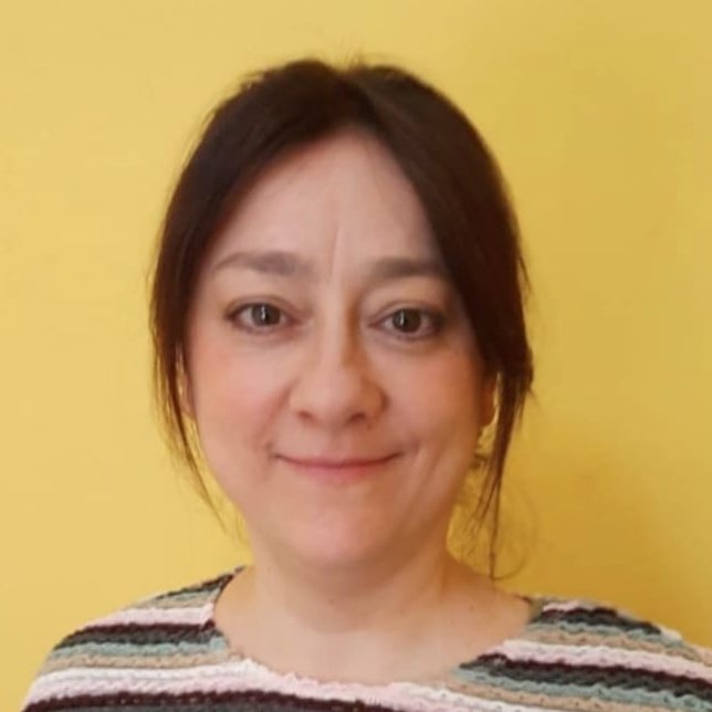 Woman with dark hair pulled back, against a yellow background