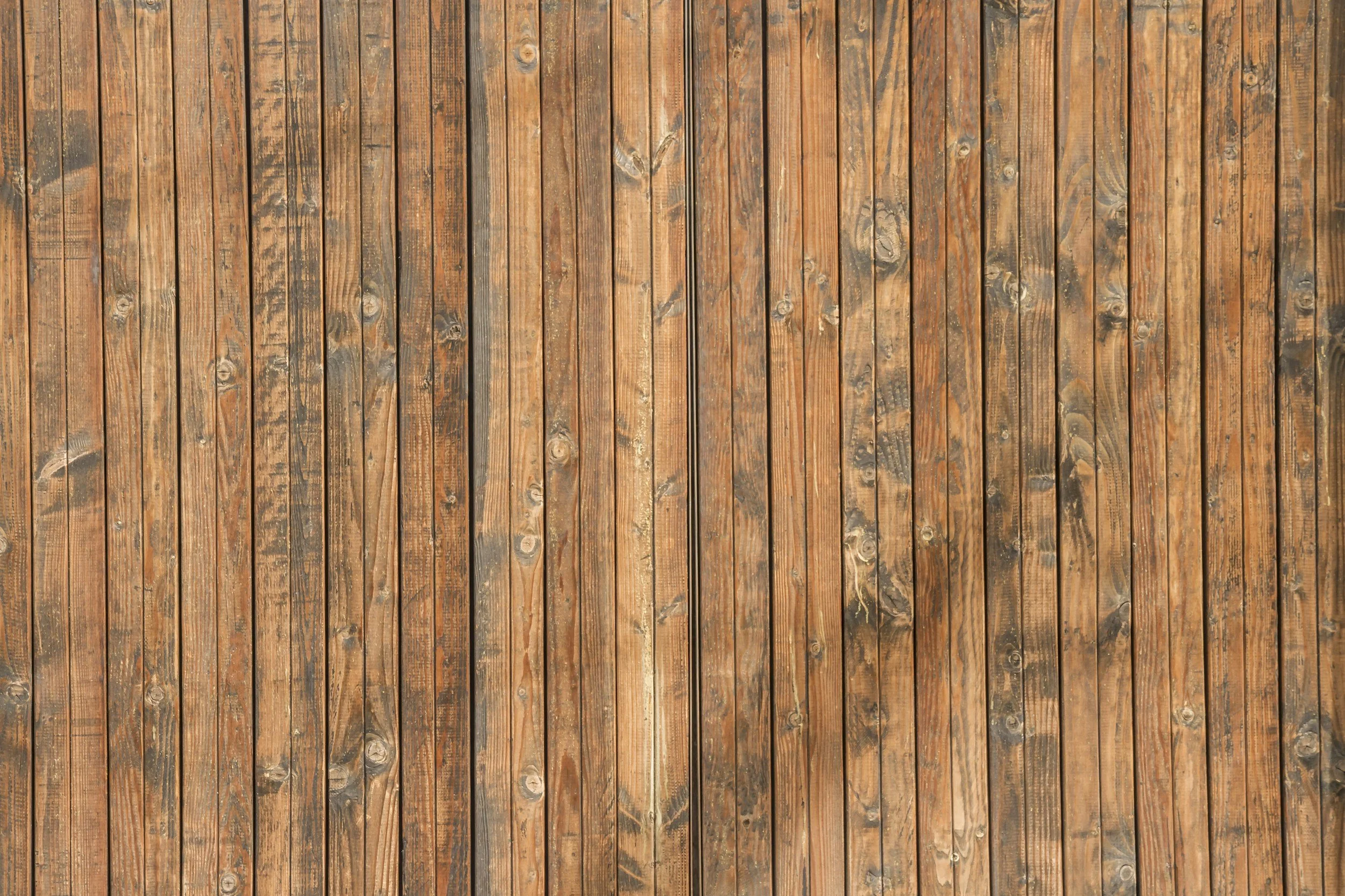 A close-up view of a wooden fence with vertical planks.