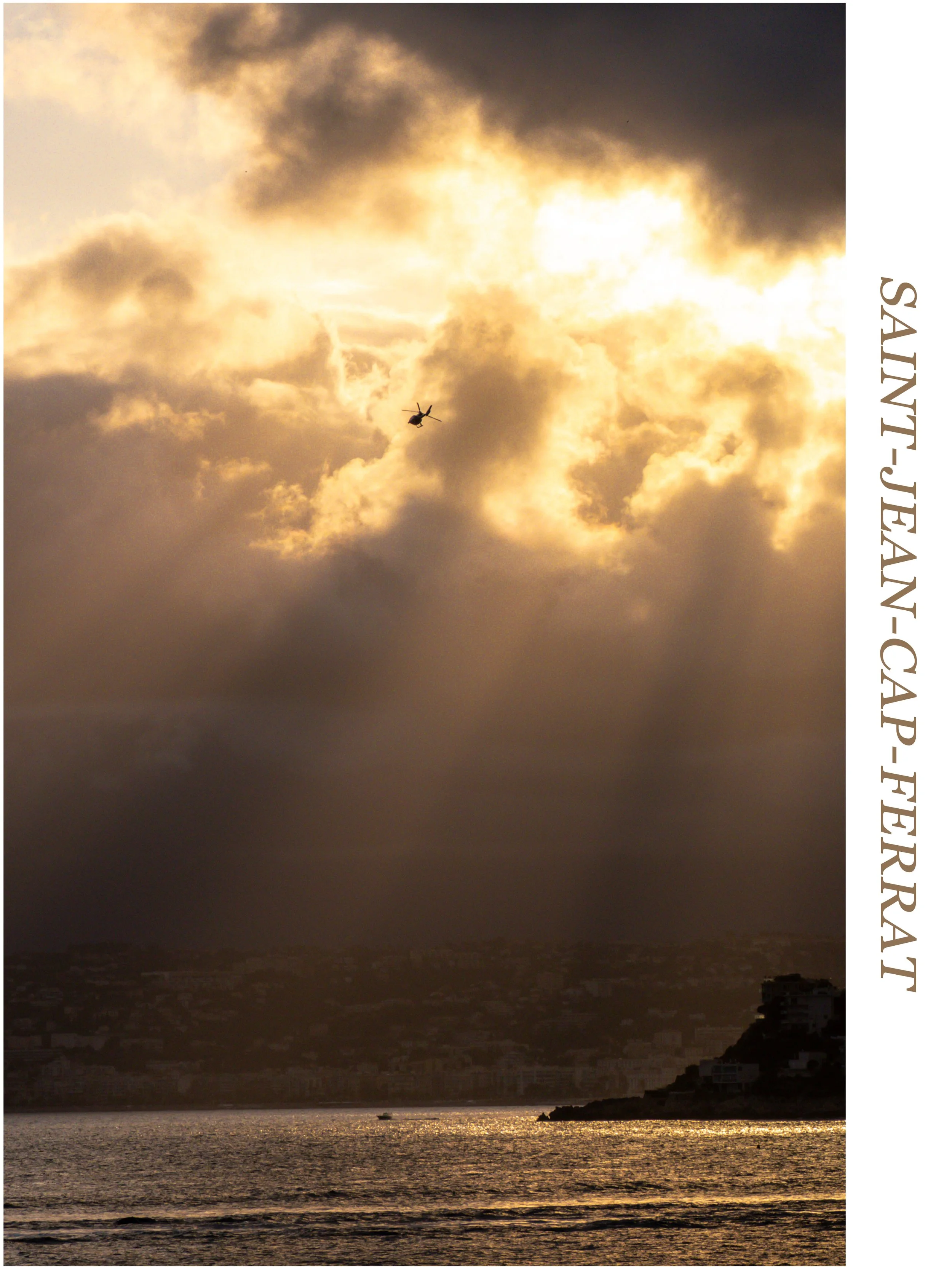 Sunset over San Juan, Puerto Rico, with dark clouds, a helicopter flying, and a waterbody in the foreground.