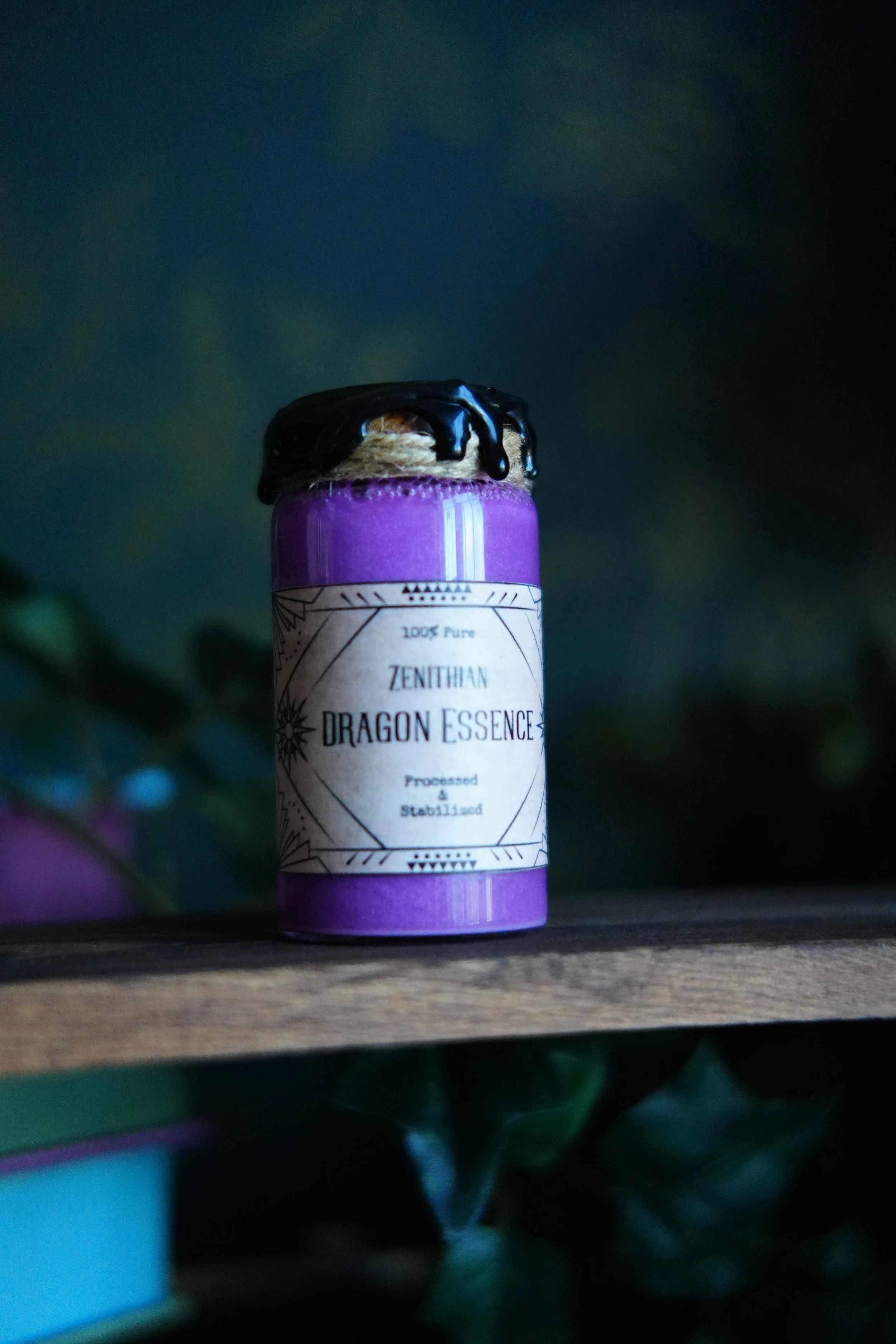 Small, purple decorative potion with a label that reads "Dragon Essence"