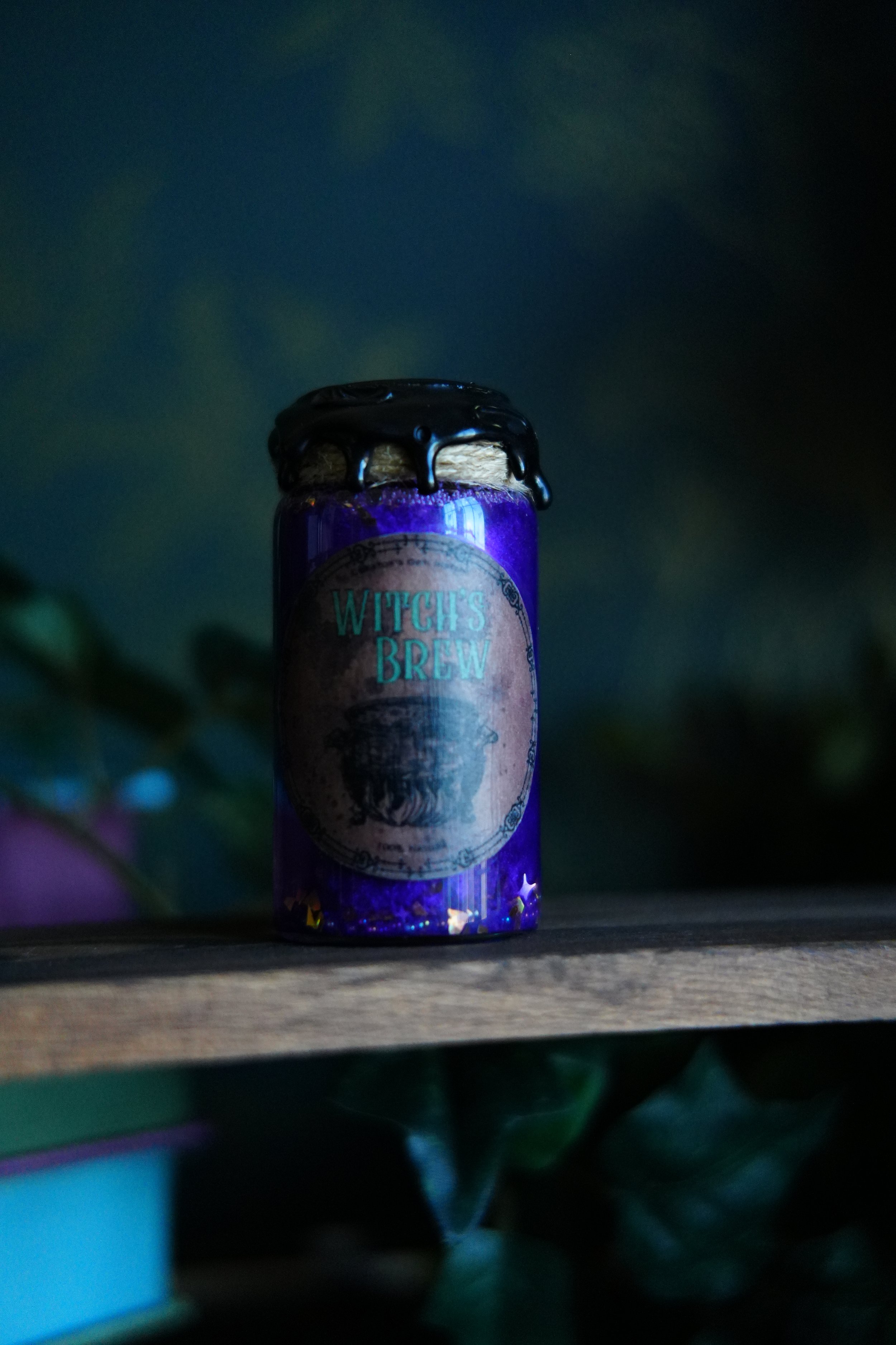 Small, purple decorative potion with a label that reads "Witch's Brew"
