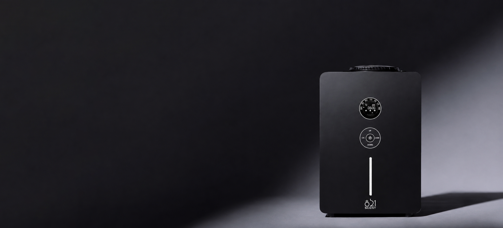 A black, rectangular electronic device with a digital display, circular control buttons, and the text '851 SCENT' on the front, set against a dark gradient background.