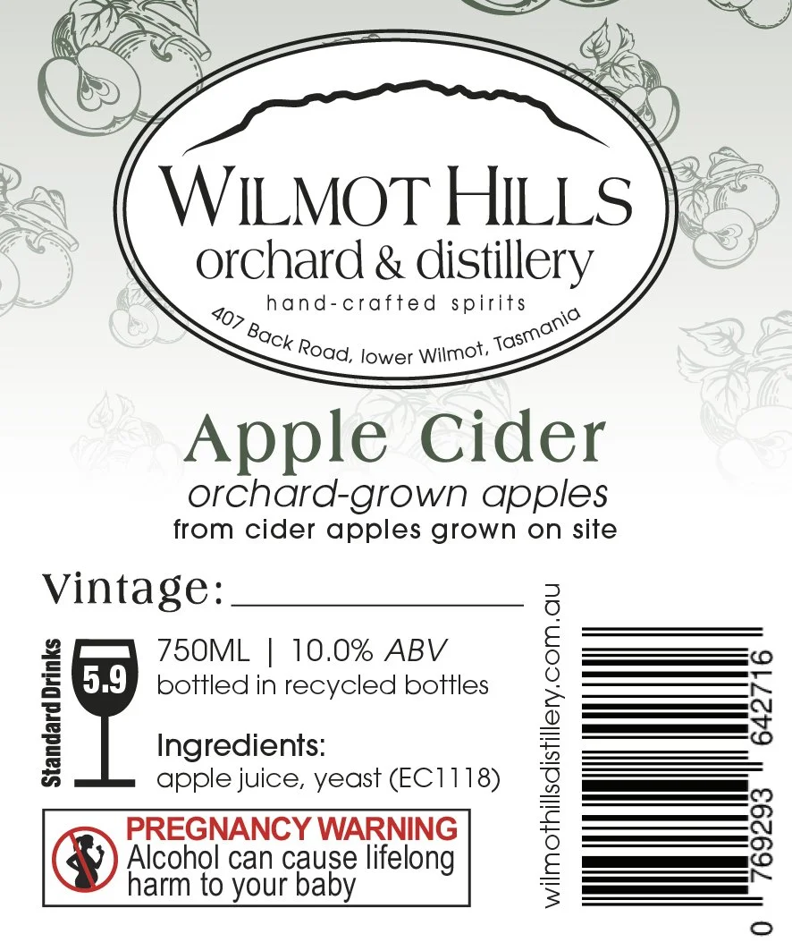 Label for Wilmot Hills orchard and distillery apple cider, showing ingredients, alcohol content, volume, barcode, and a pregnancy warning.