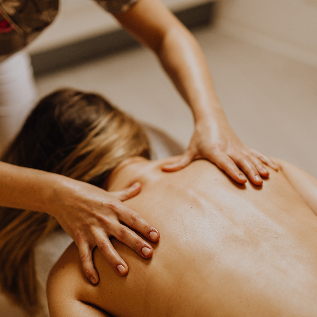 Person receiving a back massage from a massage therapist