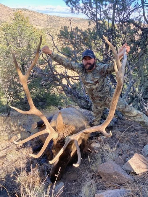 Hunter celebrating a successful guided hunt with Hook N 30 Outfitters