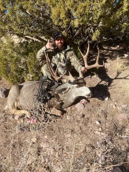 Hunter celebrating a successful guided hunt with Hook N 30 Outfitters